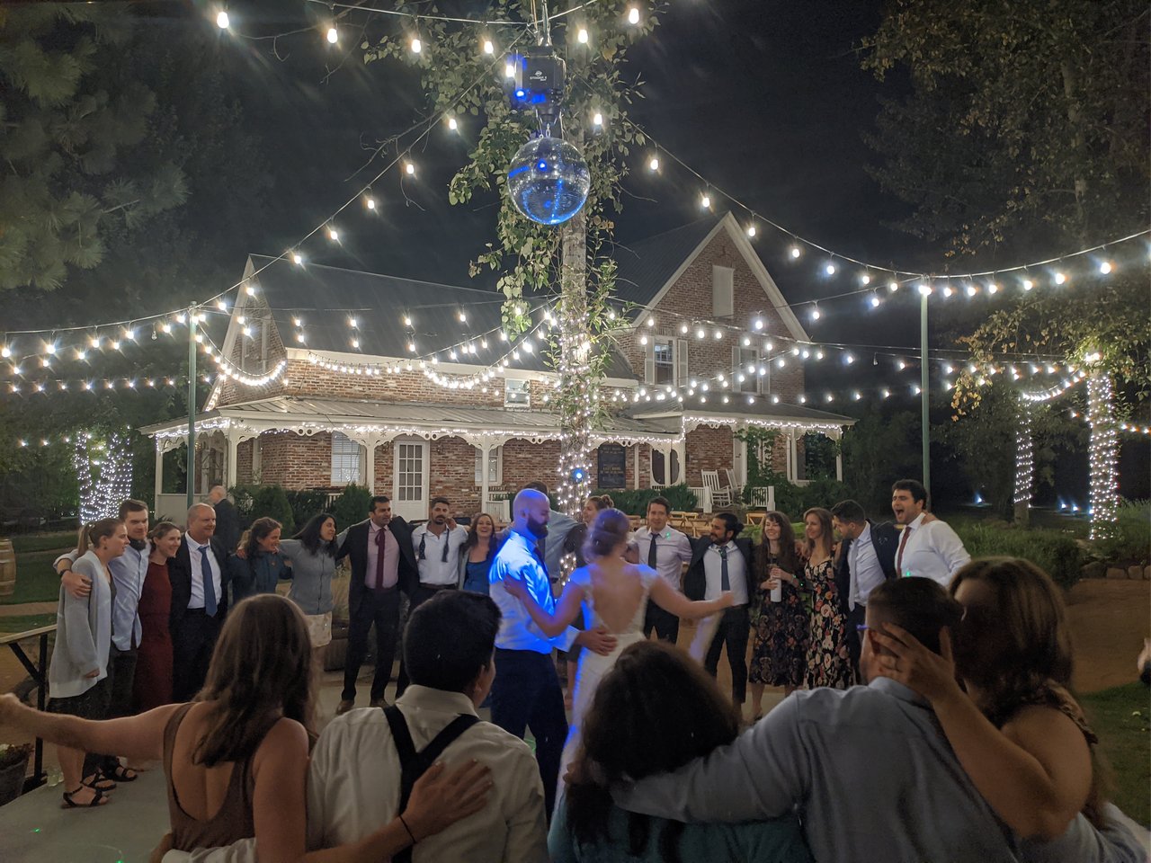 Friends circle Lauren and Mark on the dance floor during the last dance