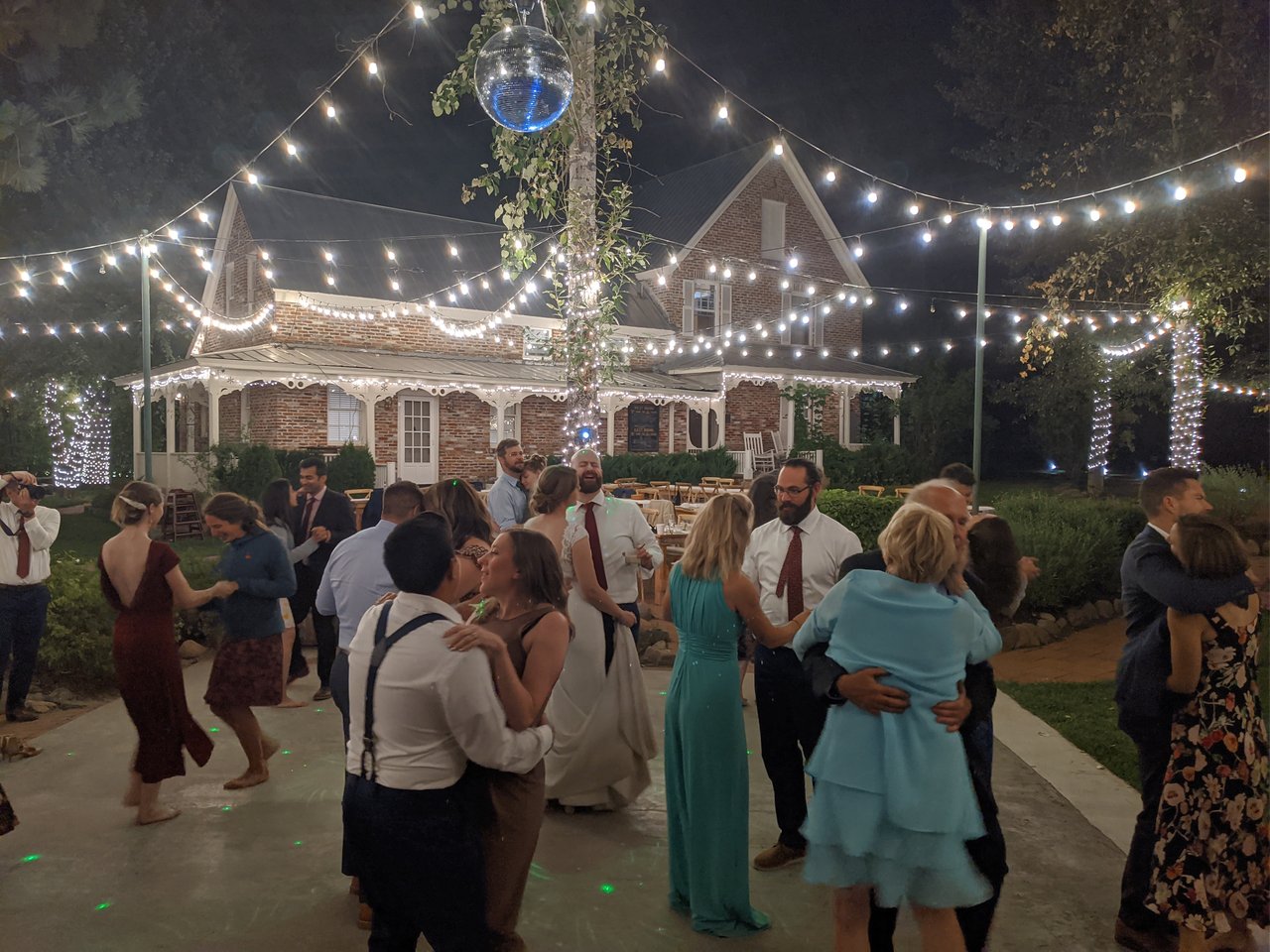 Guests share a slow dance under the string lights