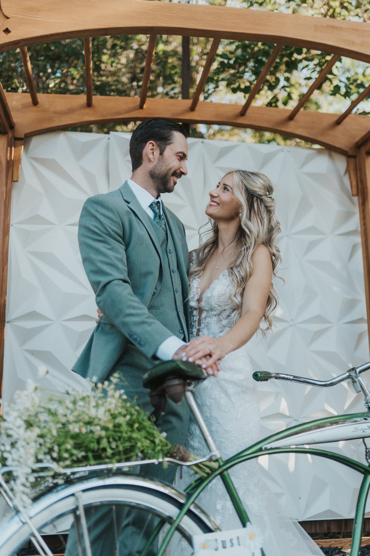 Lexy and Jeremy with the bike under the arbor