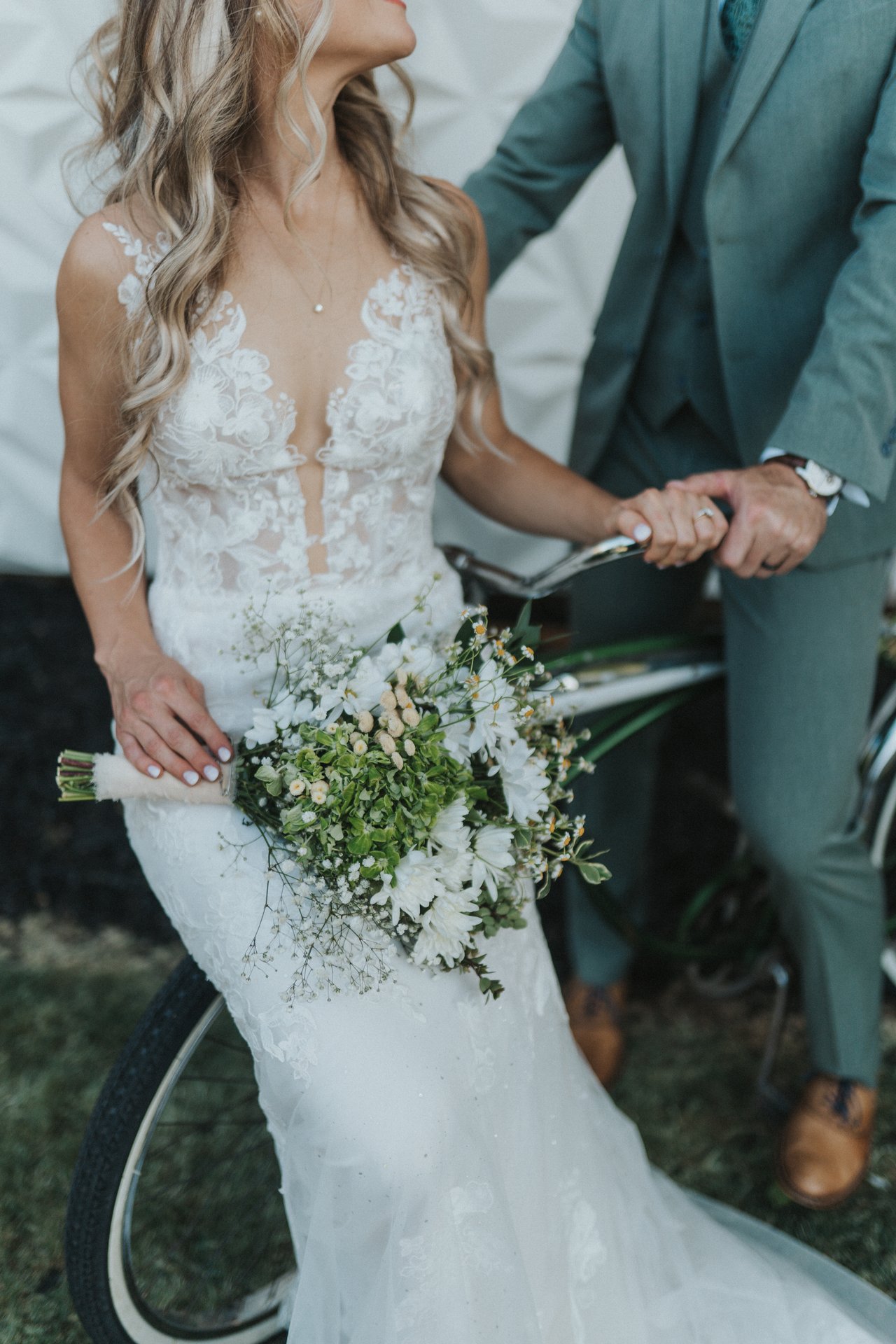 Lexy holds her bouquet beside the bike
