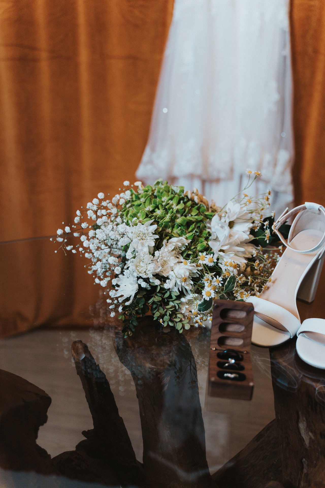 Lexy's bouquet, heels and rings in front of her dress