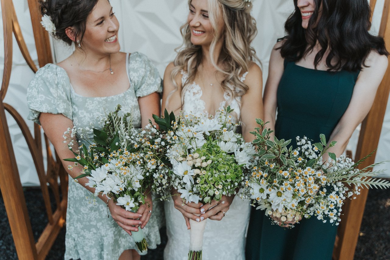Lexy and her bridesmaids holding their bouquets