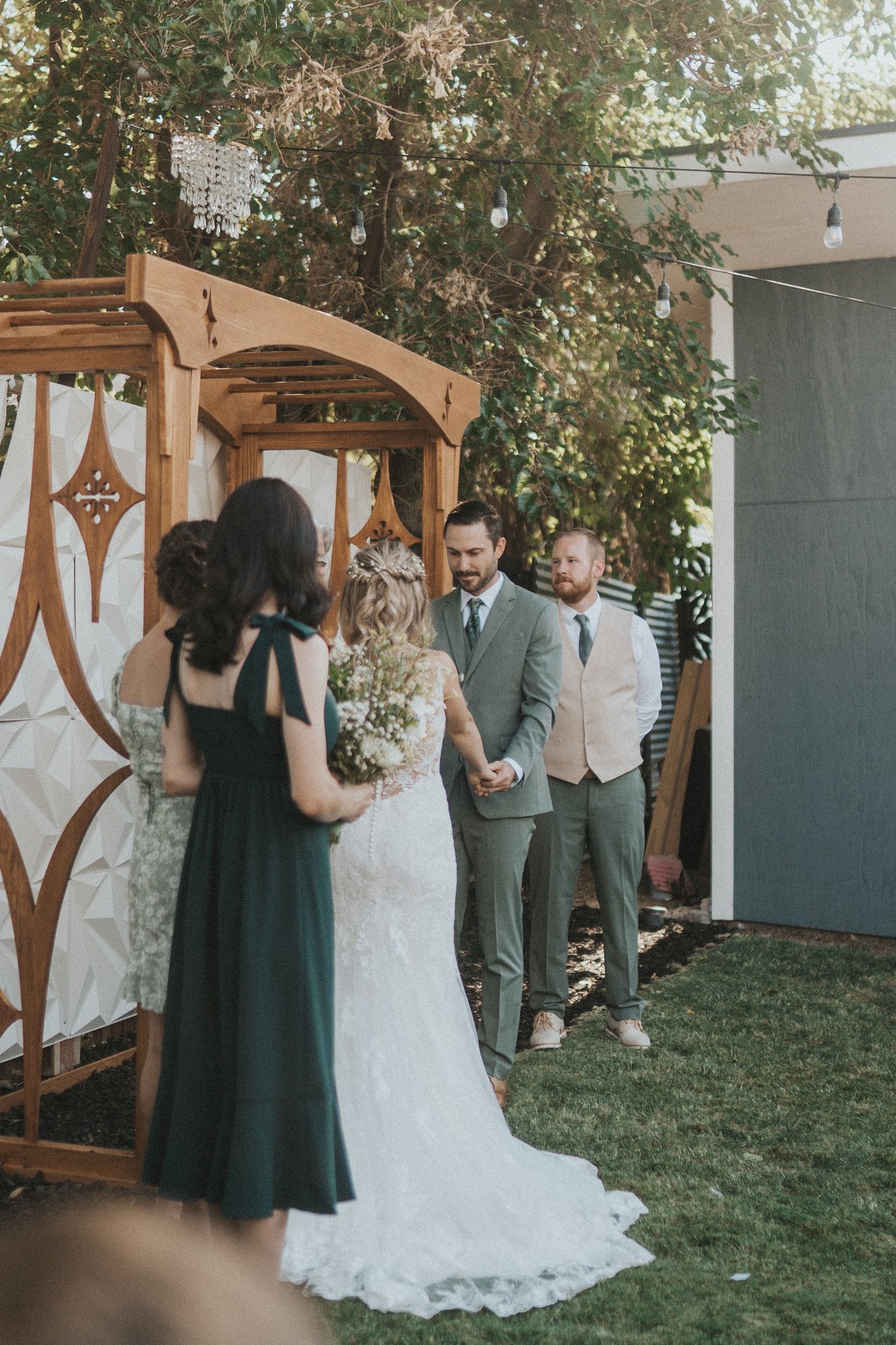 A bridesmaid beside Lexy at the arbor