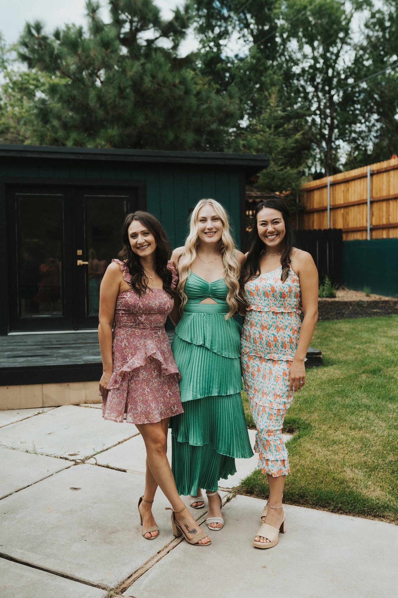 Three bridesmaids posing in the backyard