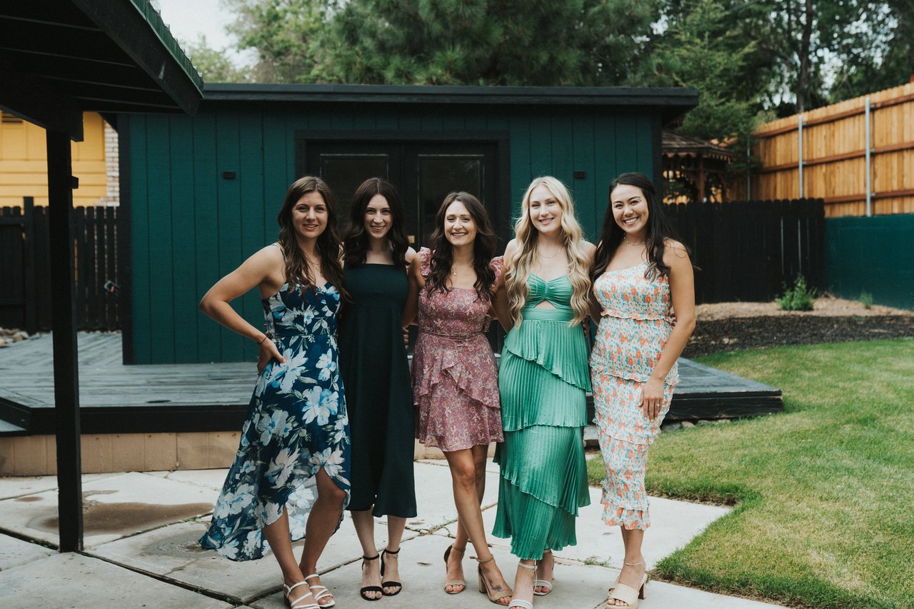 The bridesmaids lined up by the green shed