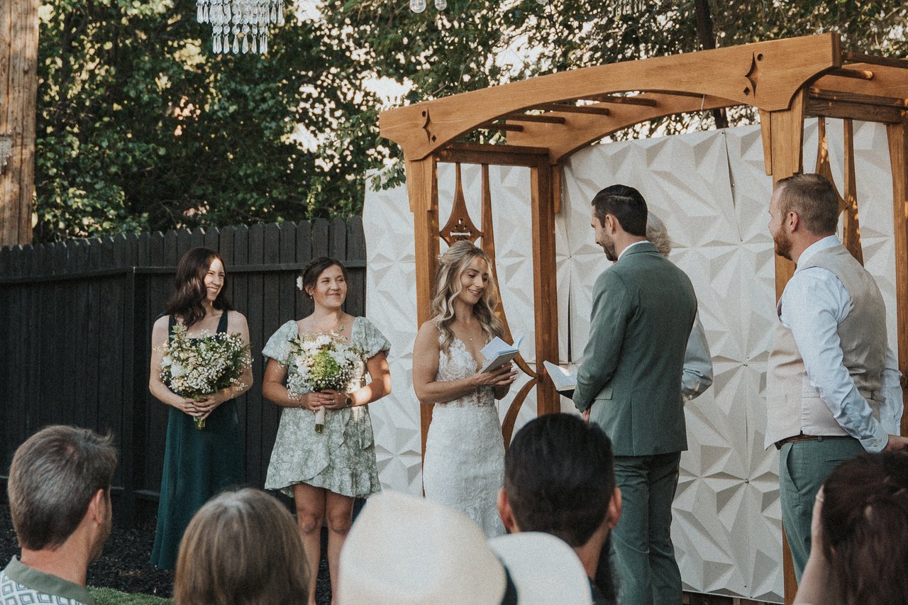 The backyard ceremony framed by the guests