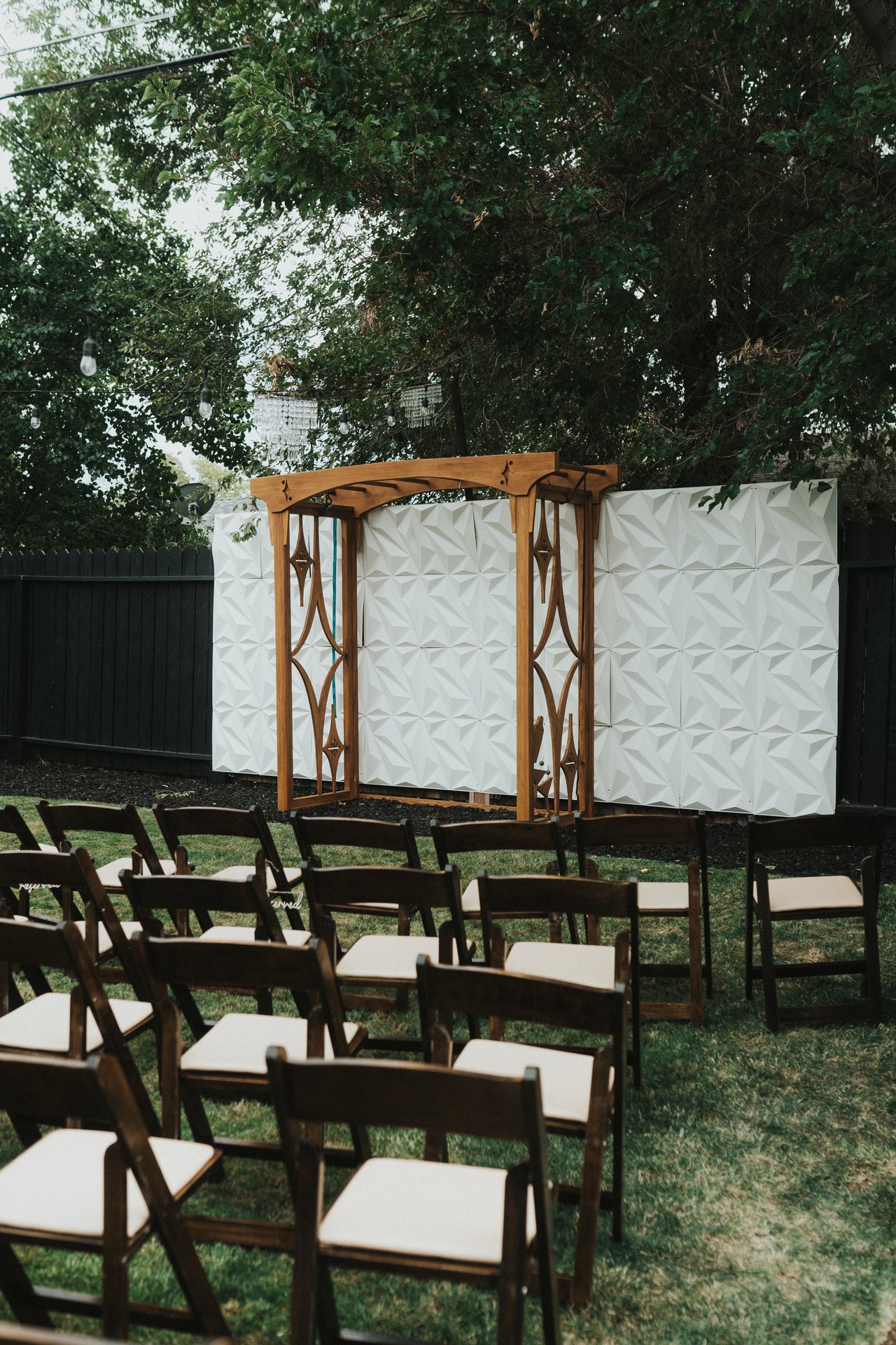 Rows of wood chairs facing the arbor