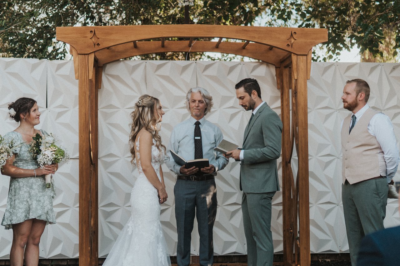 The officiant reads as Lexy and Jeremy listen