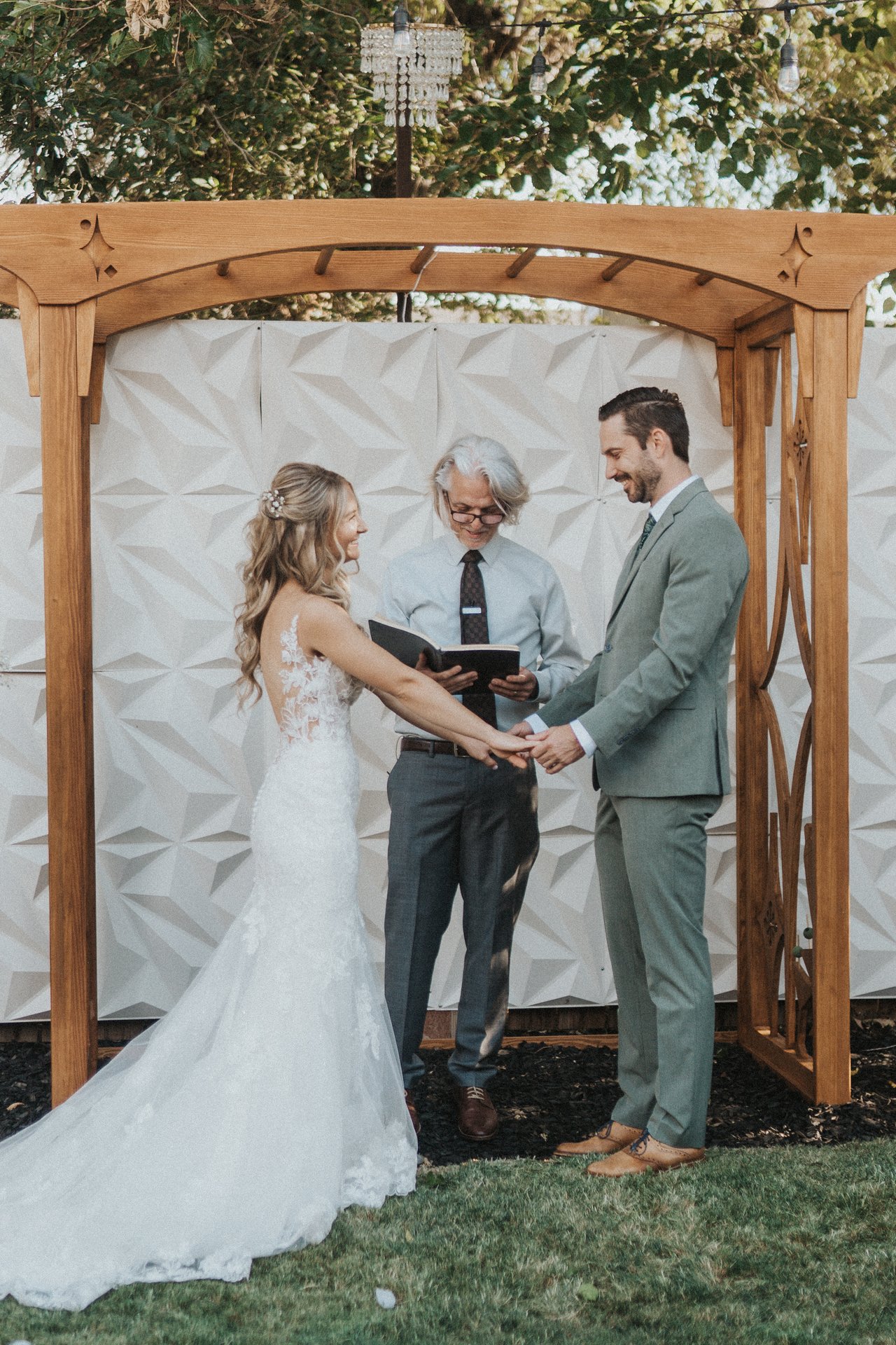 Lexy and Jeremy face each other under the arbor