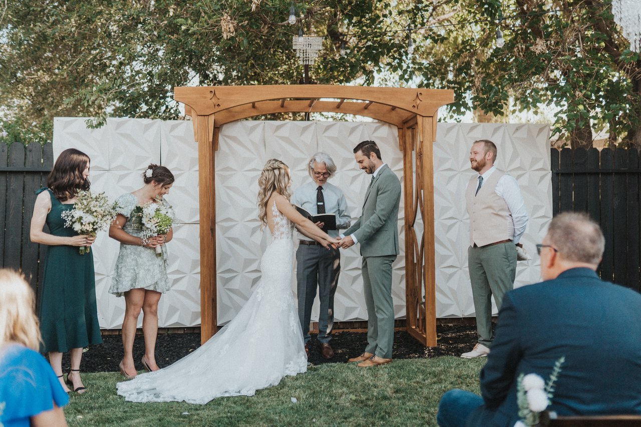 Lexy and Jeremy at the arbor with their bridal party
