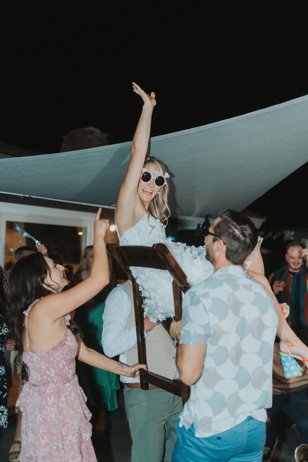 Lexy raised high in a chair above the crowd