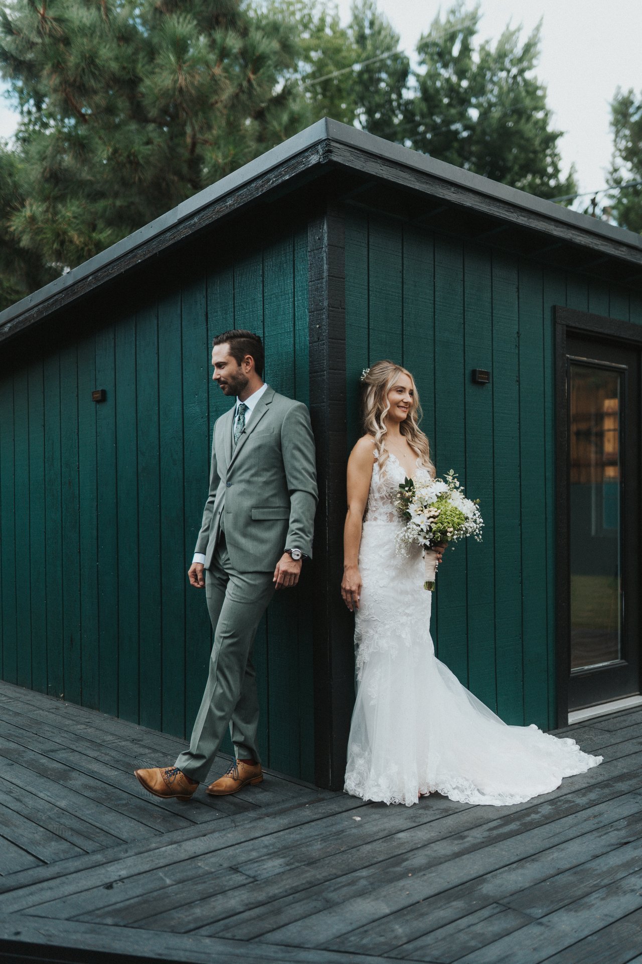 Lexy and Jeremy on either side of the shed before the ceremony