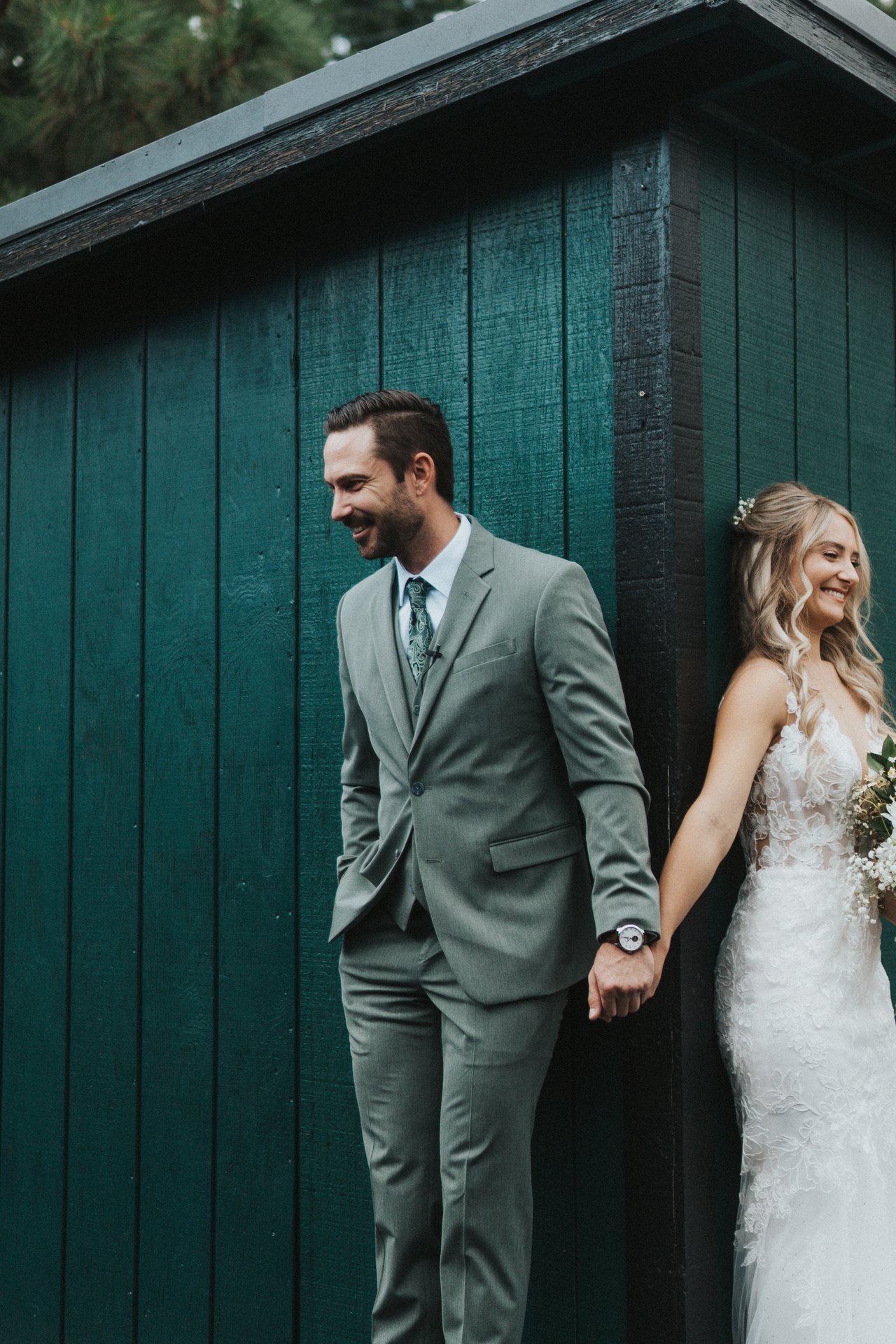 Jeremy laughs while holding Lexy's hand around the corner