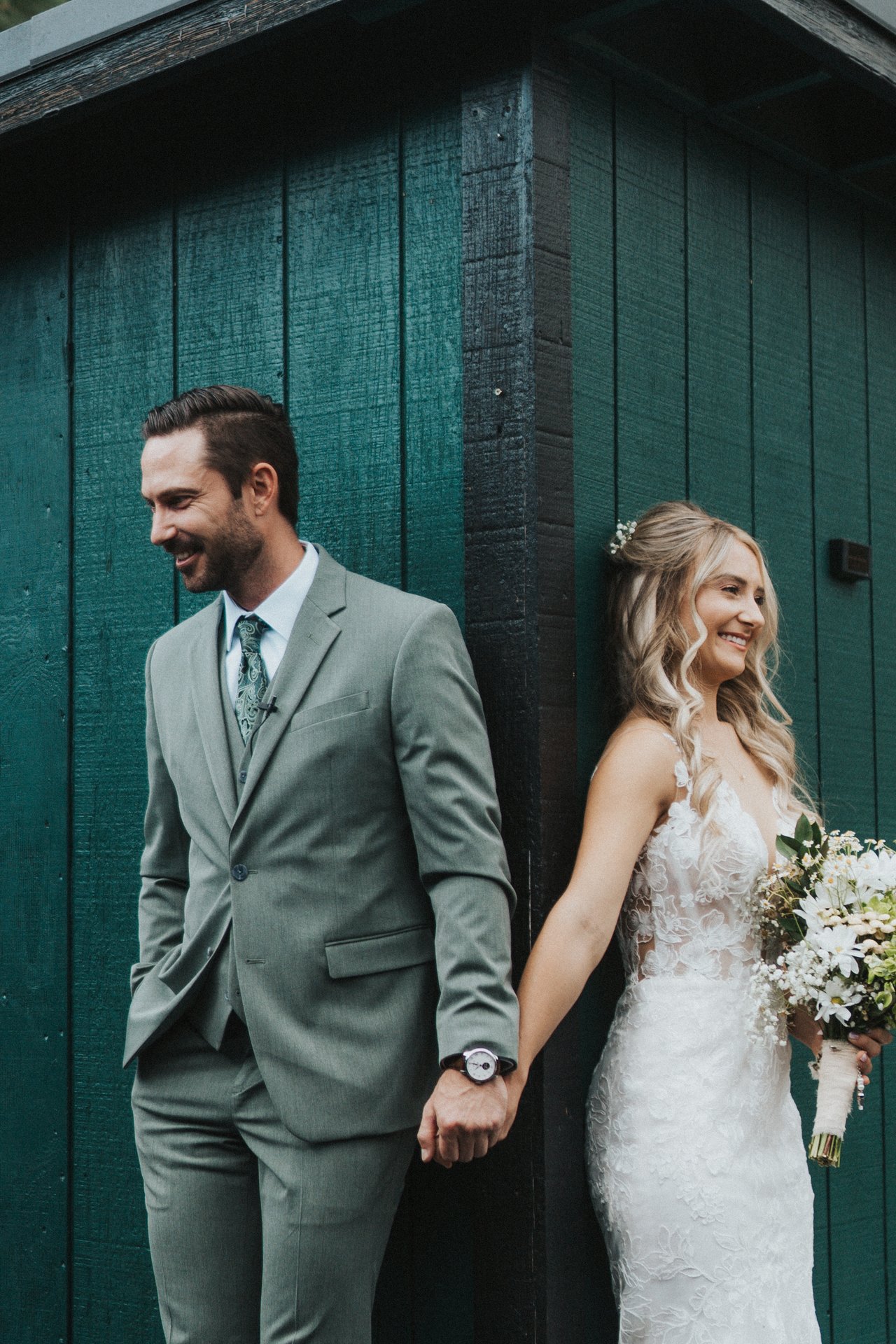 Lexy smiles holding Jeremy's hand around the corner