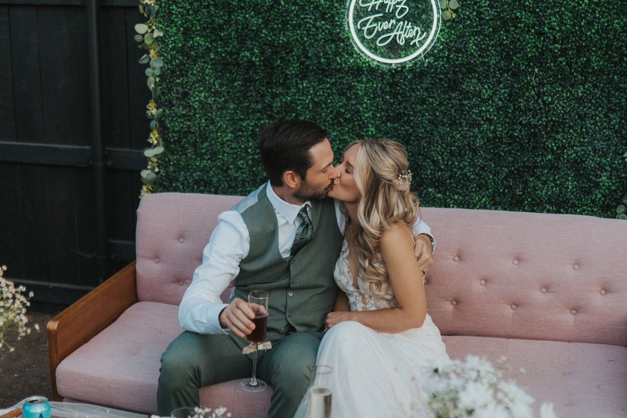 Lexy and Jeremy kiss on the couch between toasts
