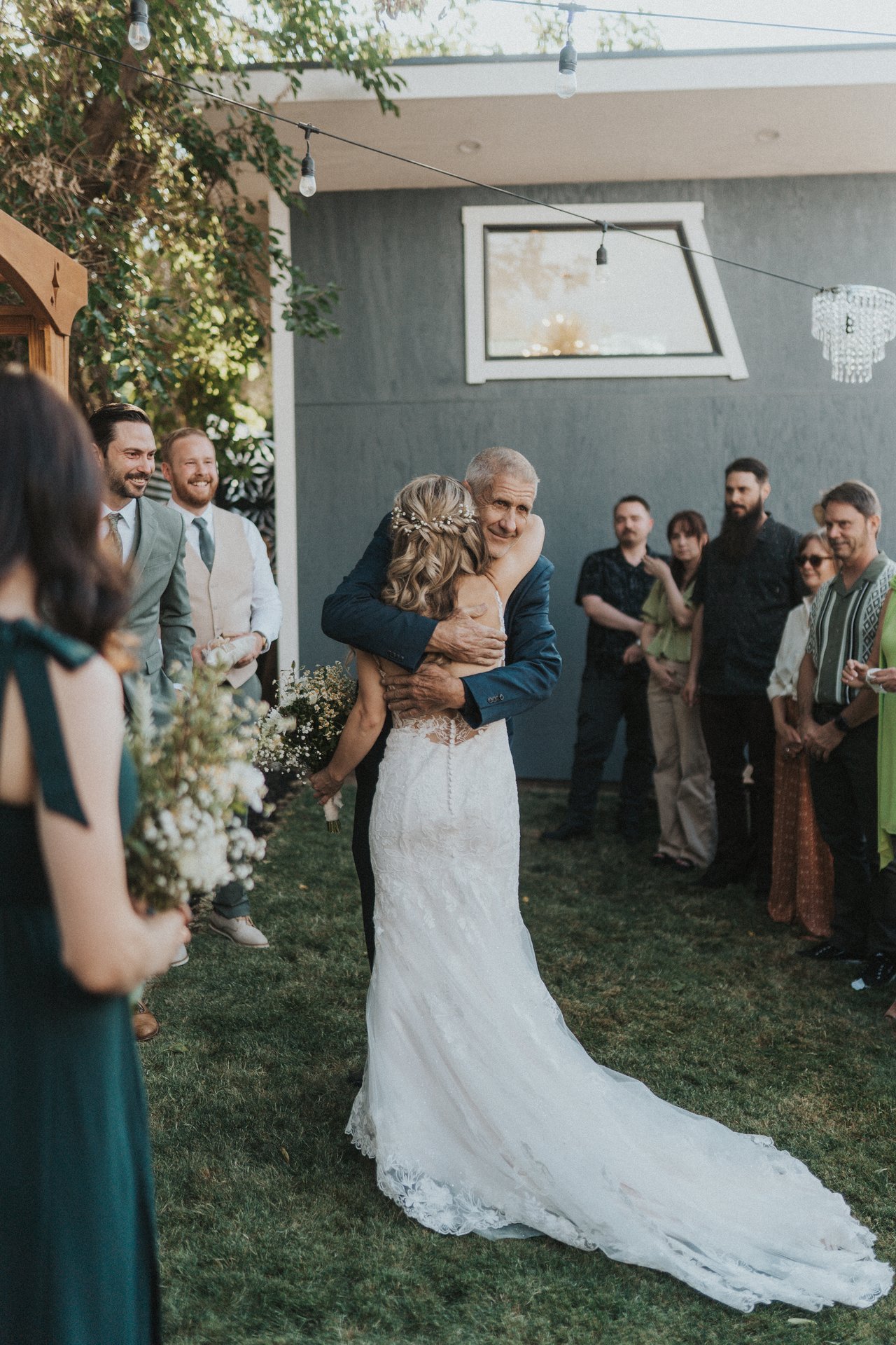 Lexy hugs her dad at the end of the aisle