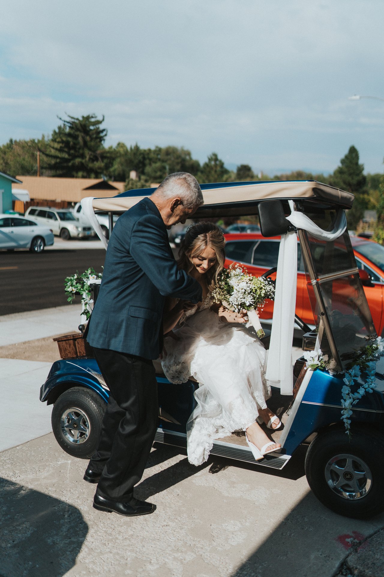 Lexy's dad helps her out of the golf cart