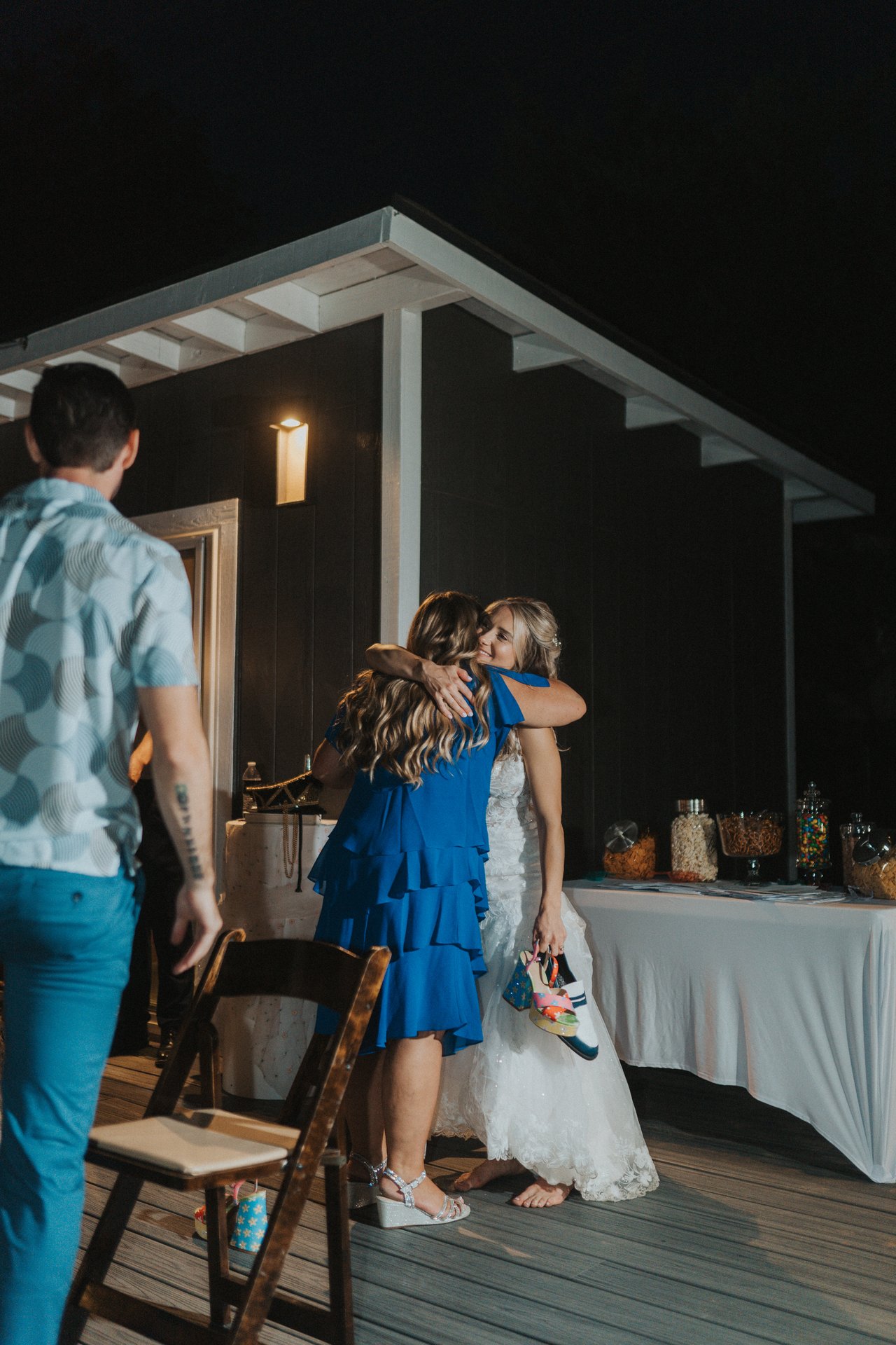 Lexy hugs a guest in a blue dress