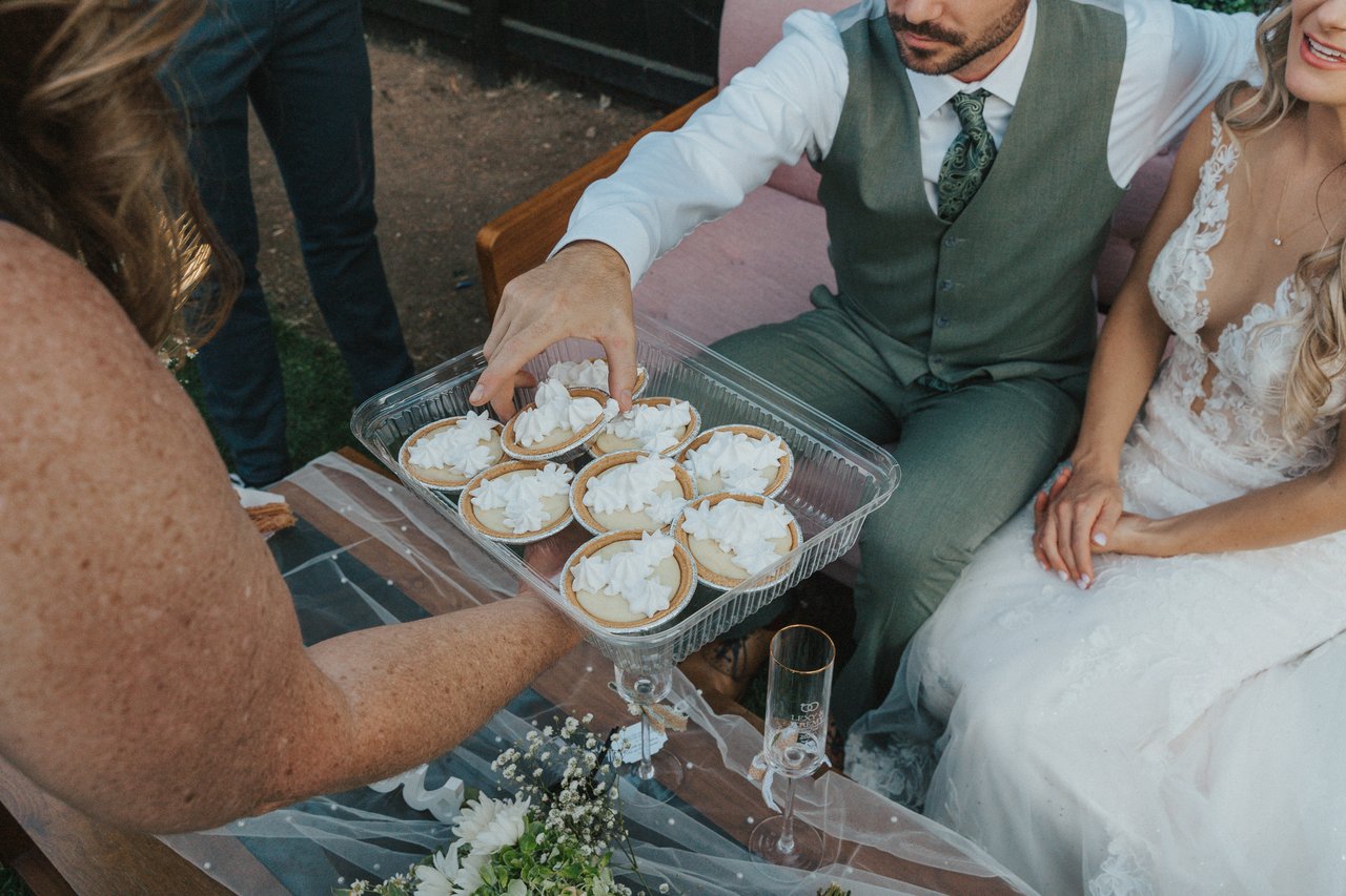 A guest brings Lexy and Jeremy a tray of desserts