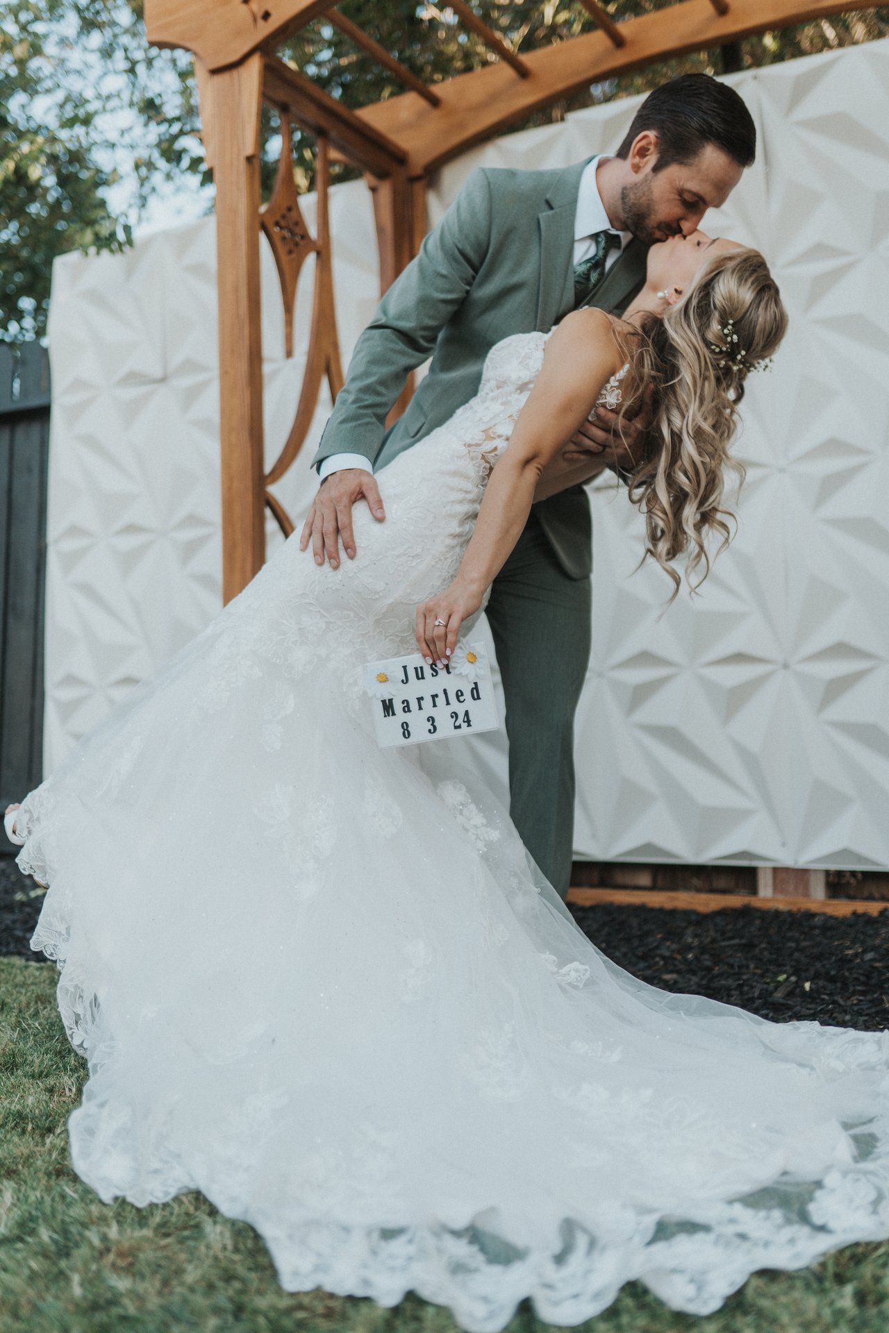 Jeremy dips Lexy for a kiss under the arbor