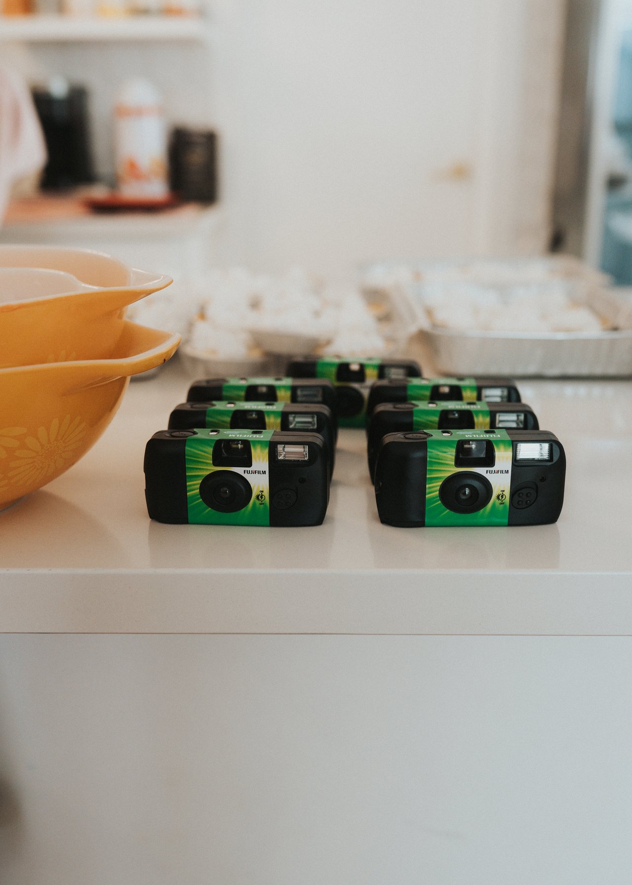 A row of disposable cameras waiting for guests