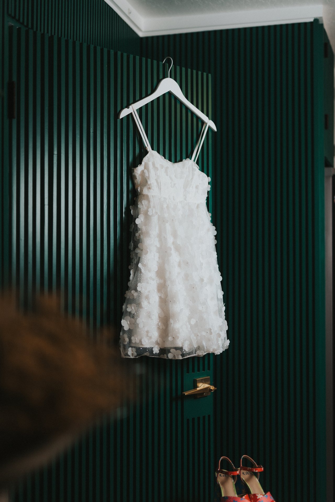The wedding dress hanging, seen wide