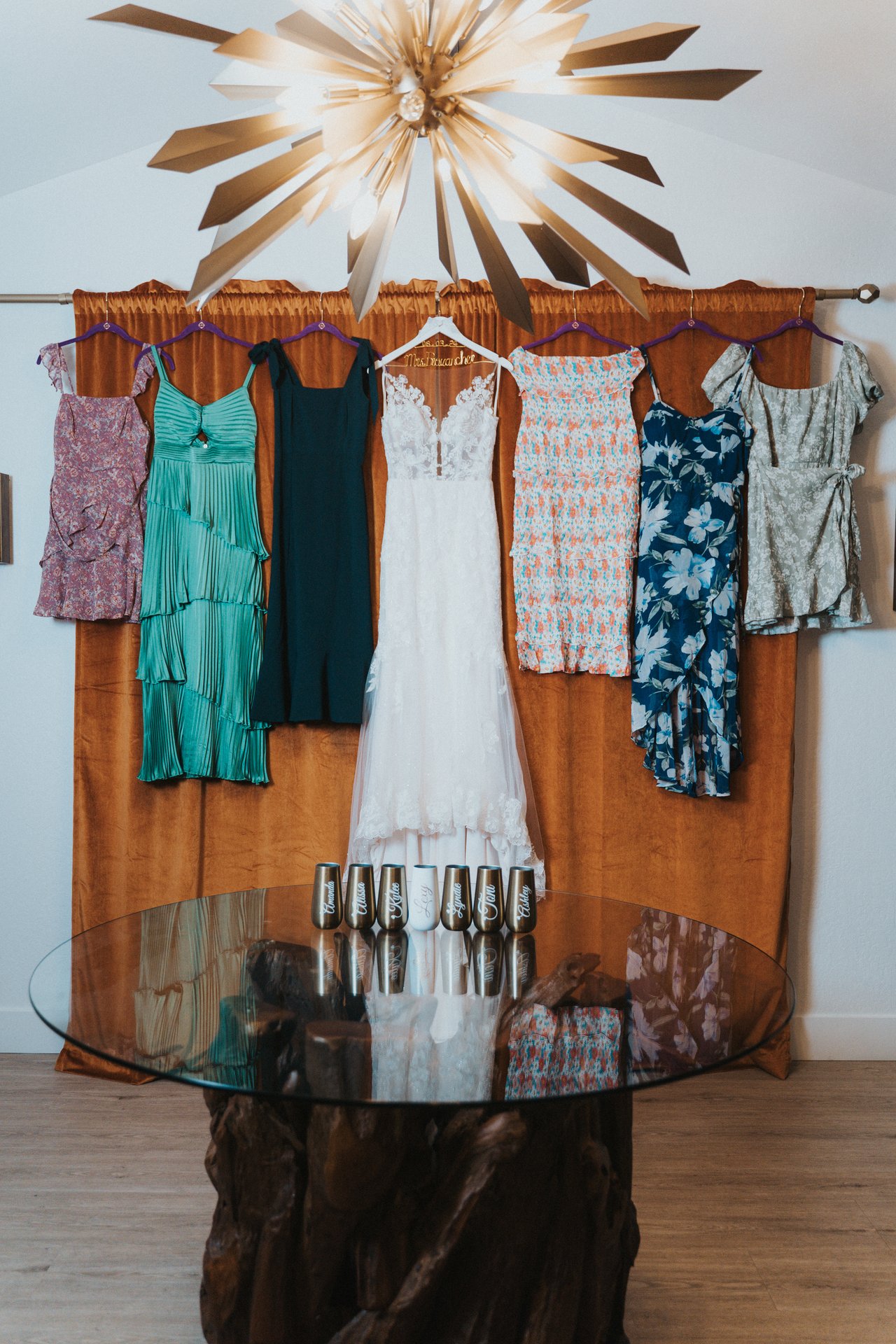 Lexy's dress hanging between her bridesmaids' dresses
