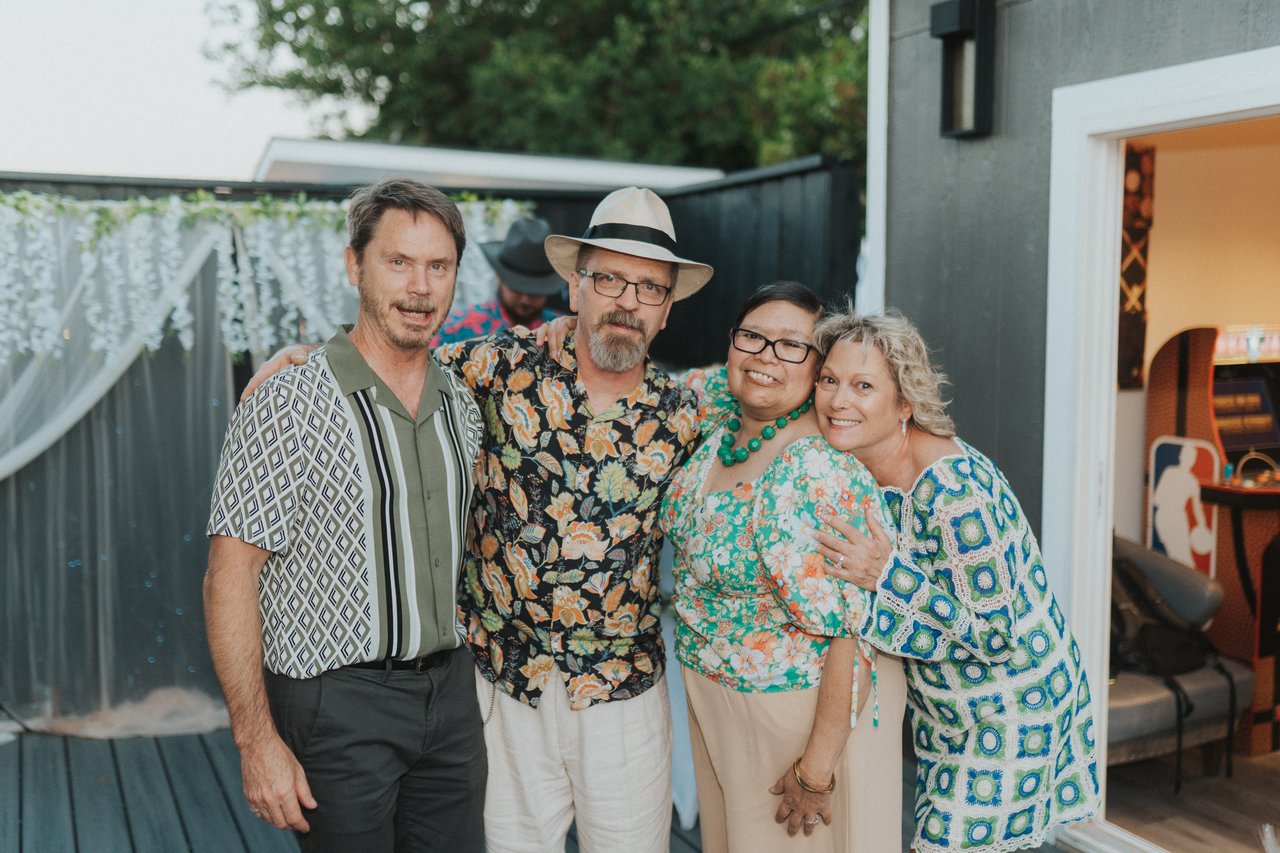 Lexy and Jeremy with their families in the backyard