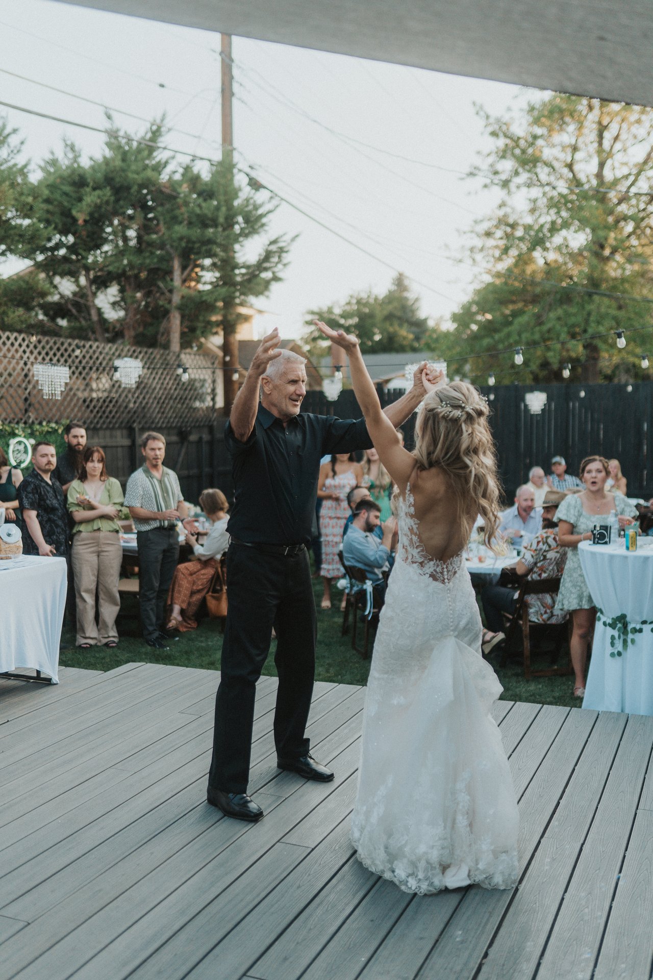 Lexy's dad twirls her on the deck