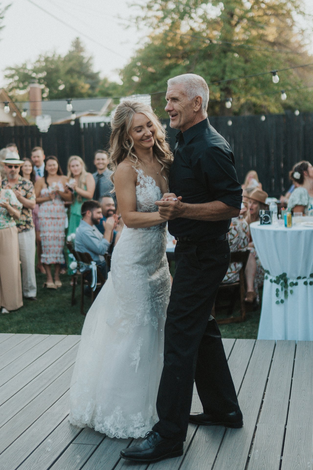 Lexy and her dad dance as guests look on