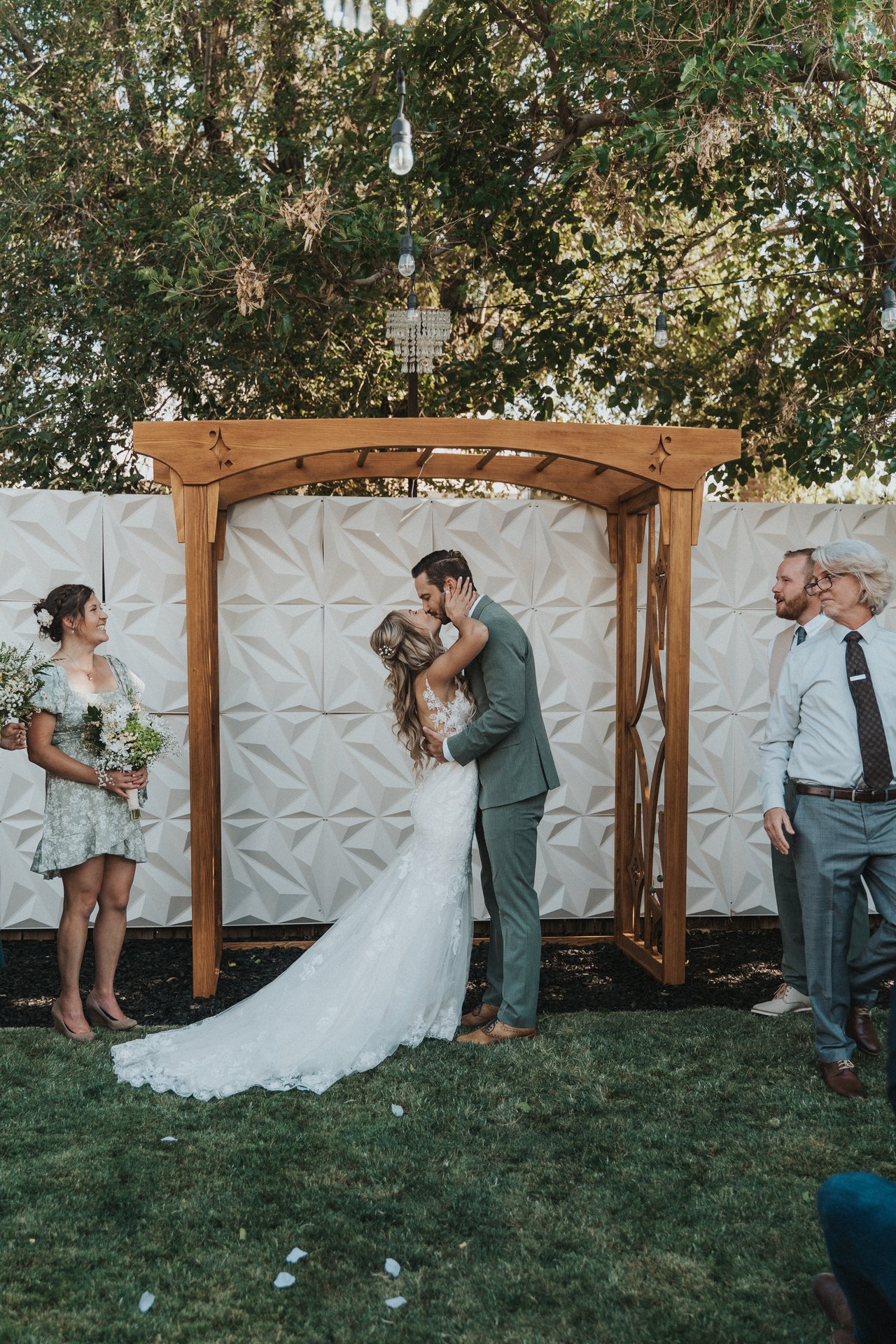 The first kiss under the wooden arbor