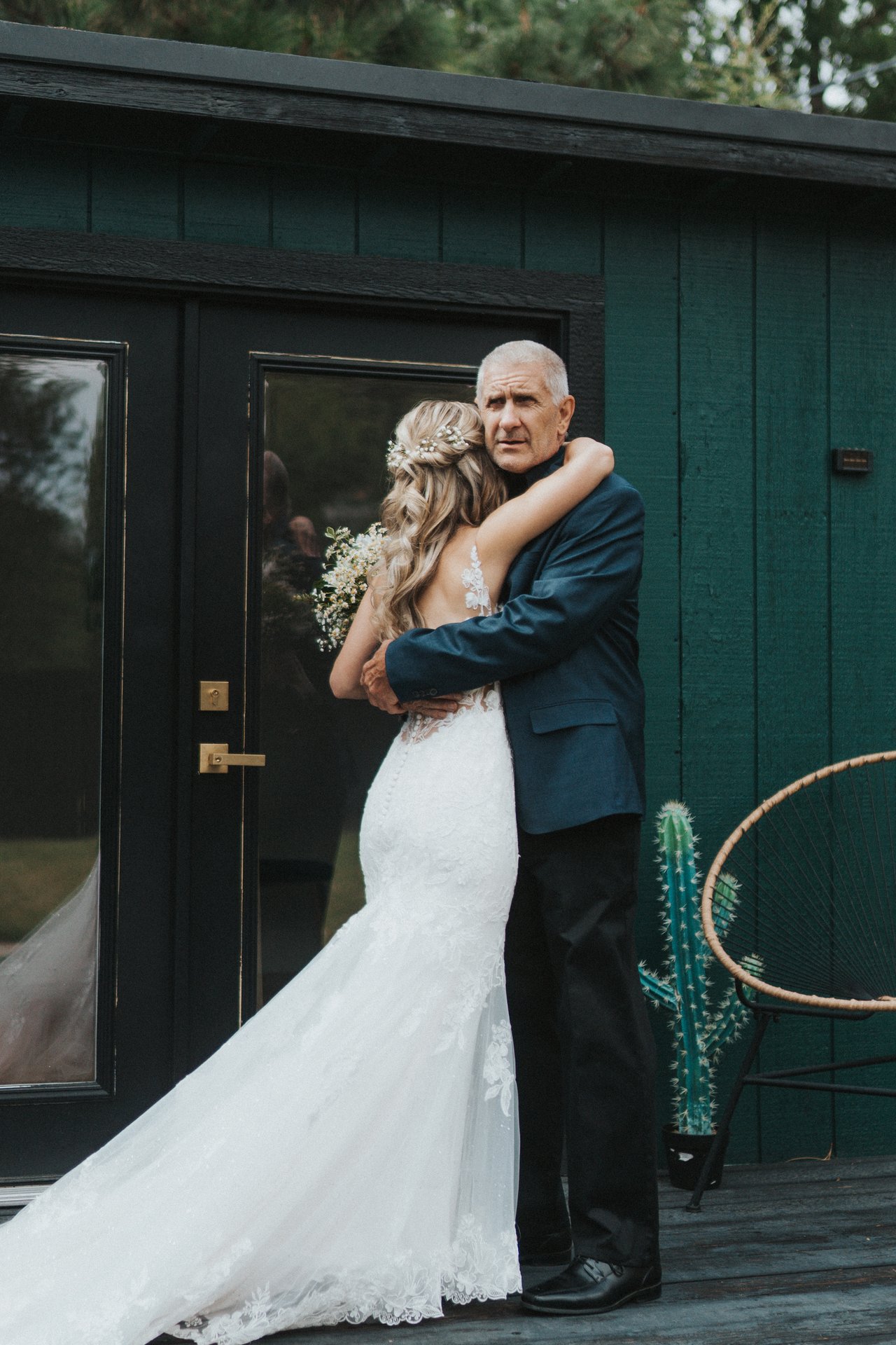 Lexy and her dad hug on the deck