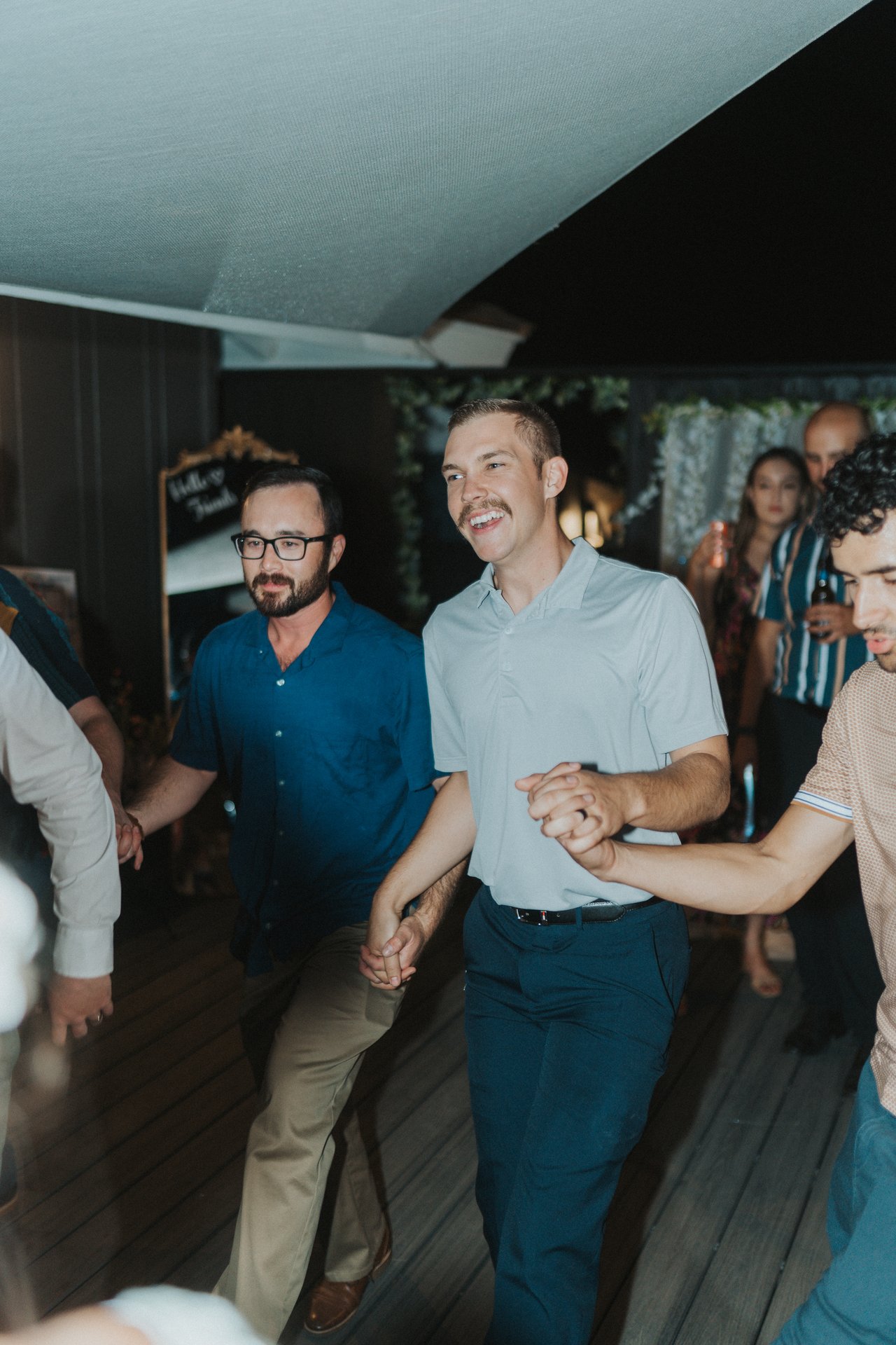 Friends dancing hand in hand