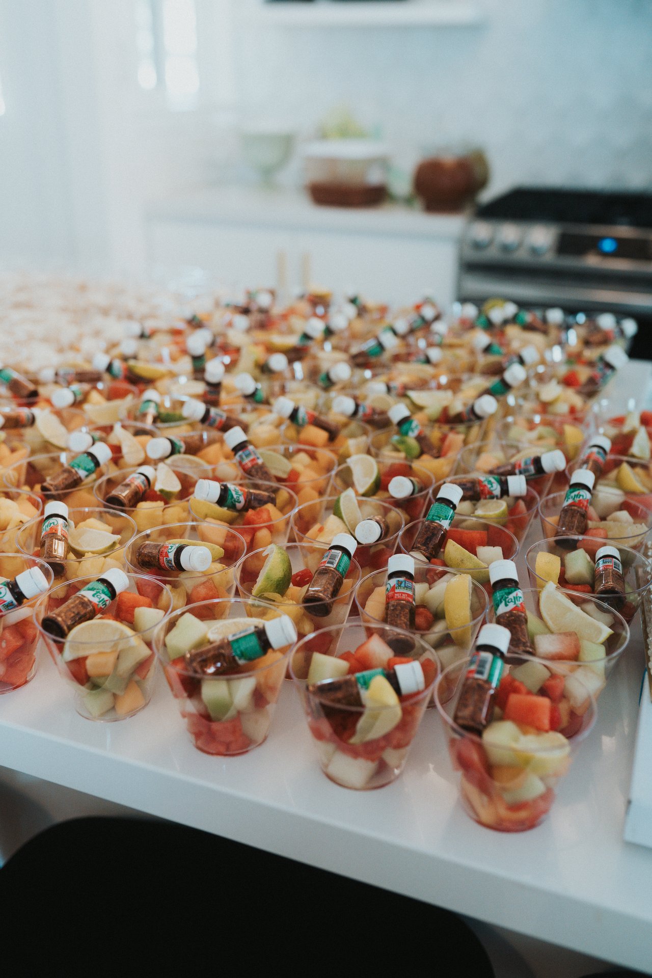 Trays of fruit cups lined up in the kitchen