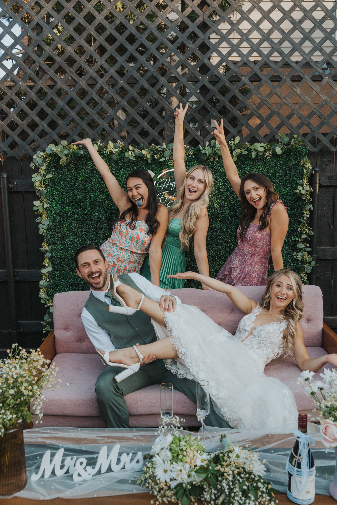 Lexy lounges across Jeremy as her friends cheer behind them