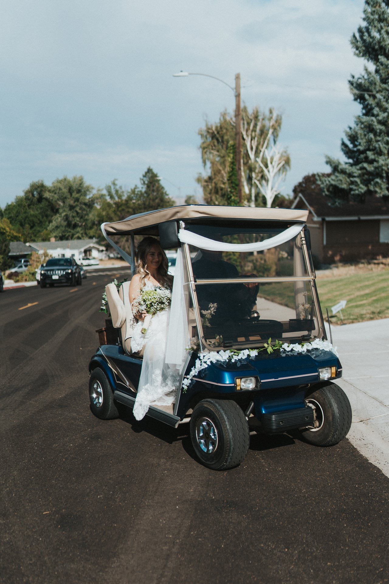 Lexy rides to the ceremony in a decorated golf cart