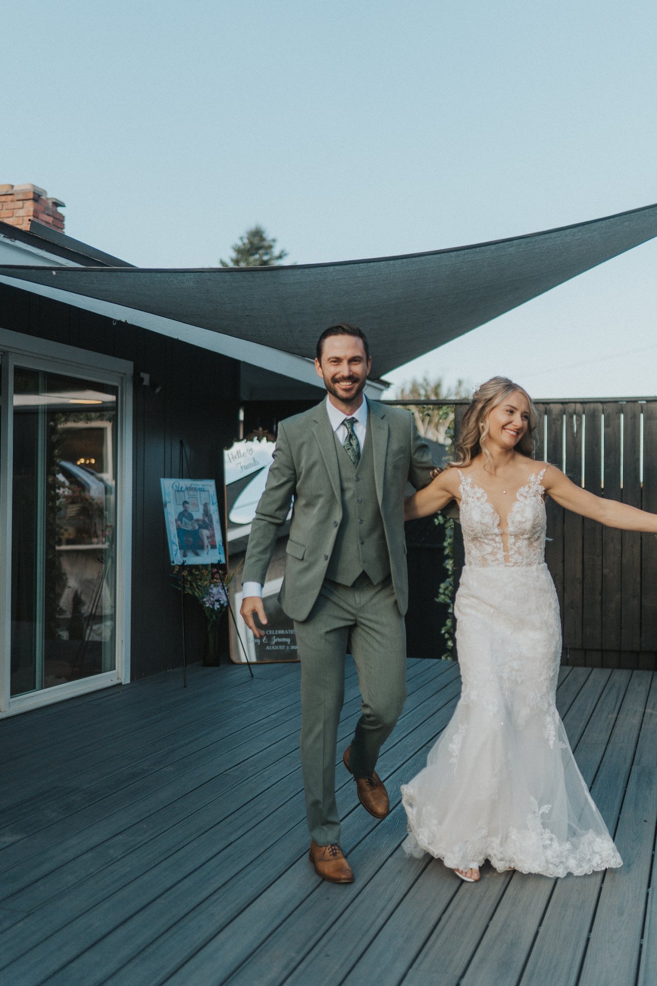 Lexy and Jeremy cheer as they enter the reception