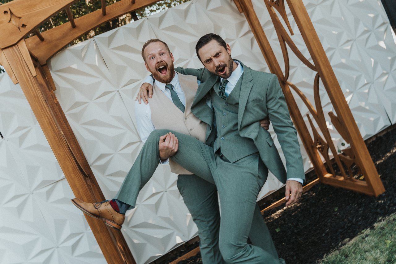 Jeremy and a groomsman goofing around at the arbor
