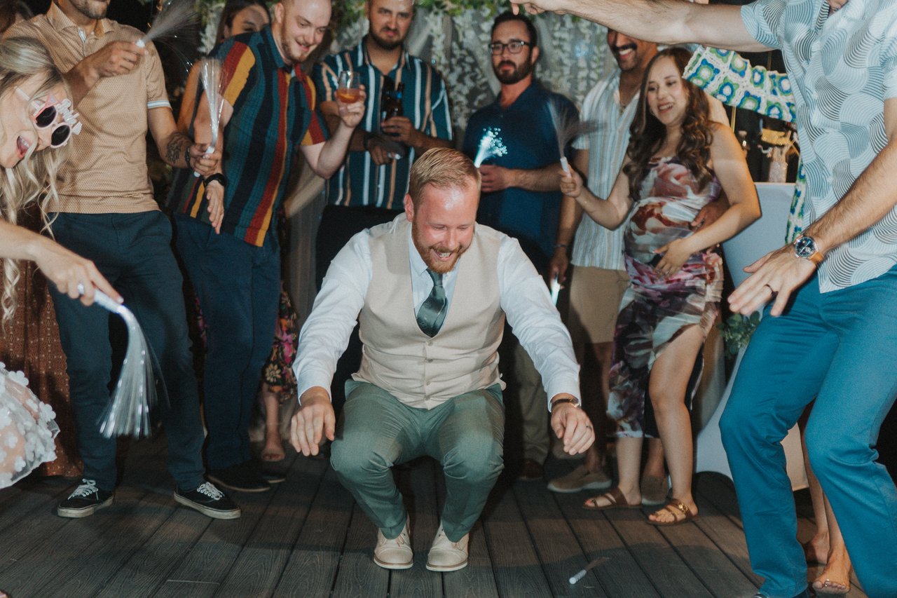 A guest in a vest drops low on the dance floor