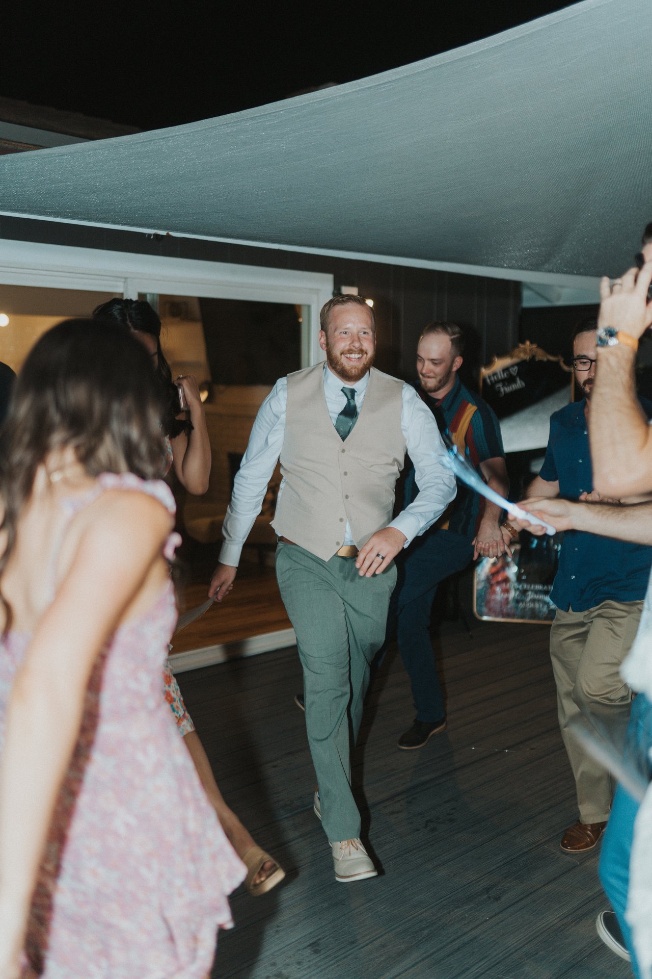 A guest in a vest dancing toward the camera