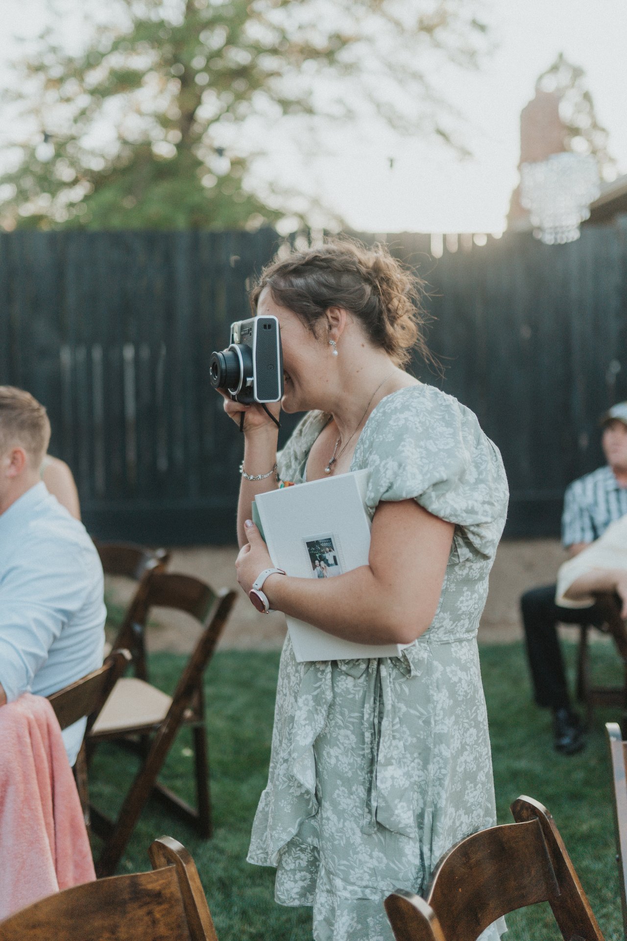 A guest snaps a photo with an instant camera