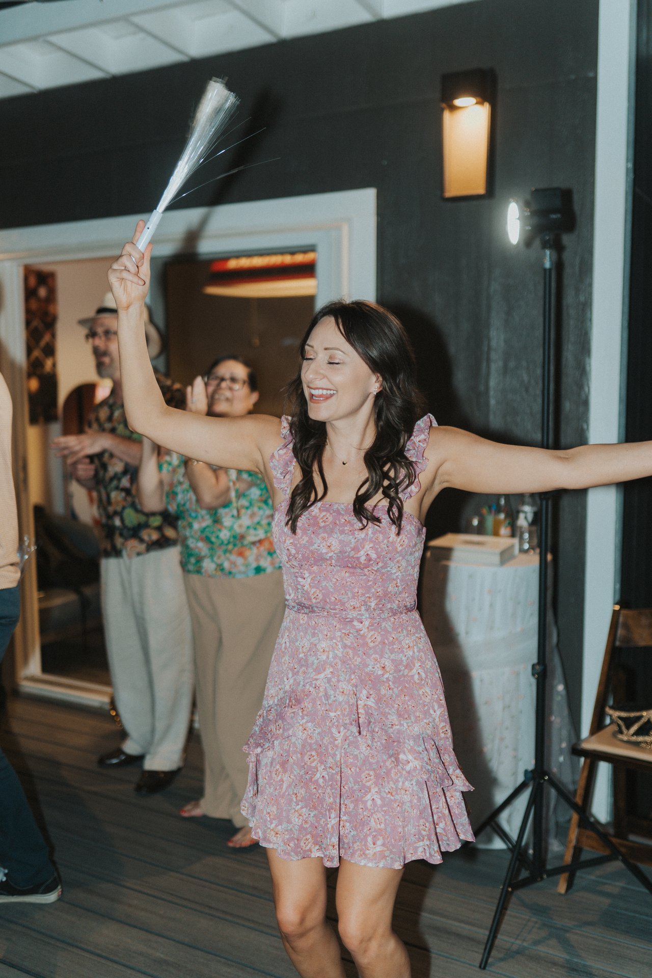 A guest dancing with a light up wand