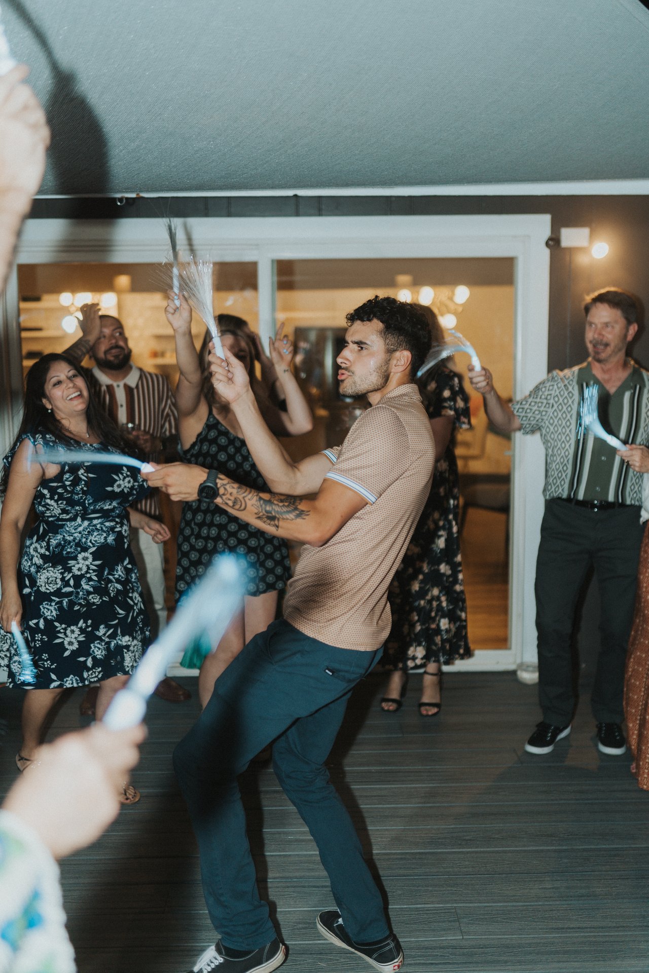 A guest dancing with a light up wand