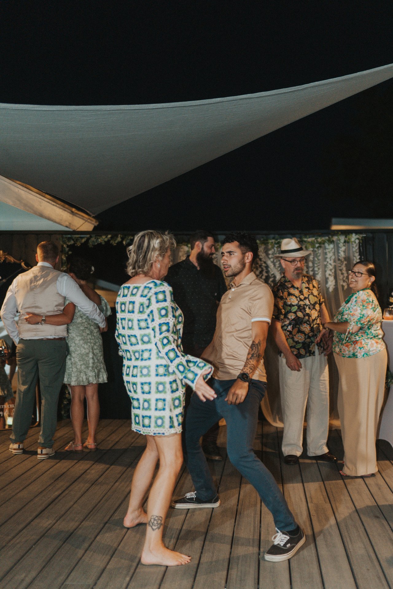 Guests dancing under the shade sail