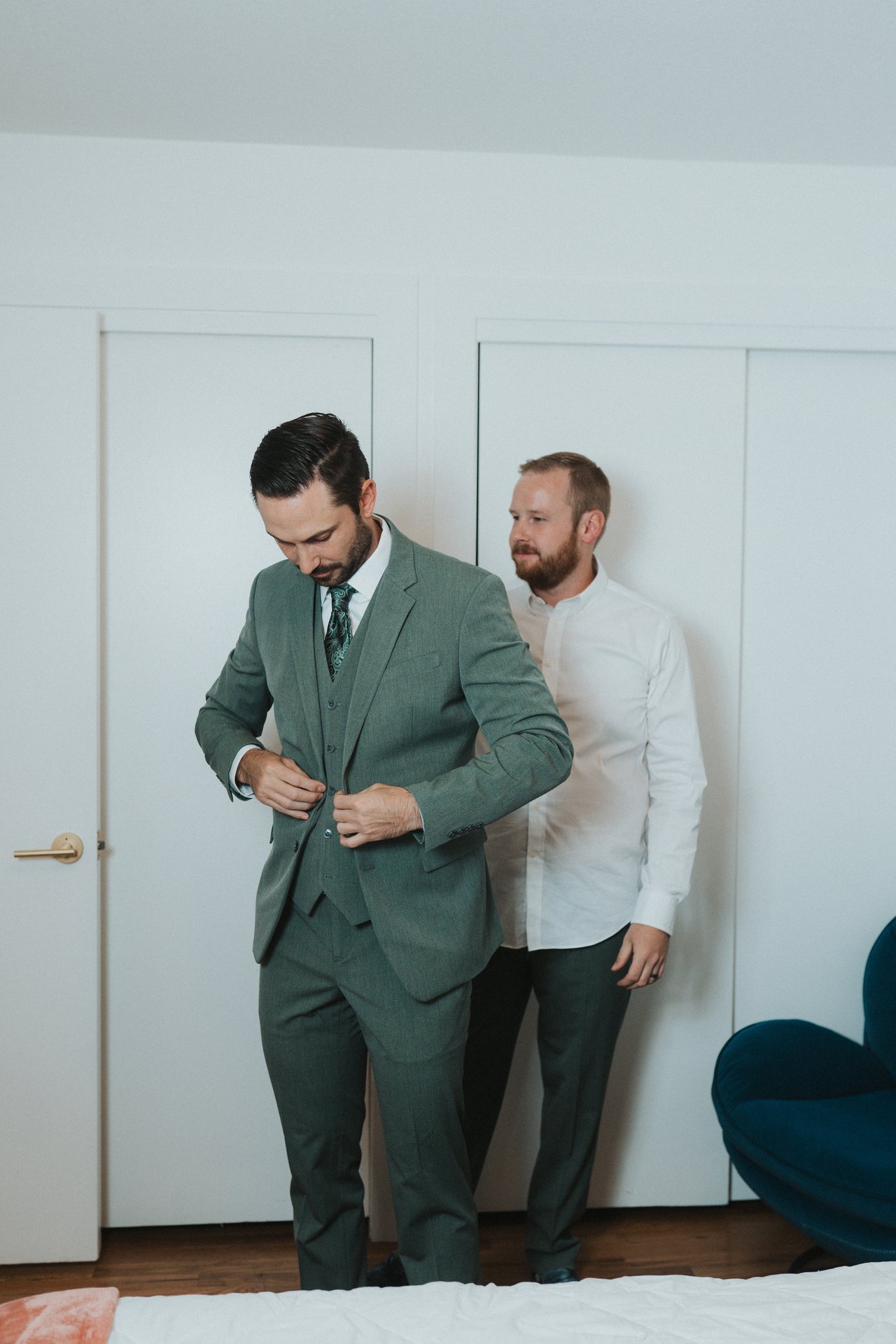Jeremy buttons his suit jacket