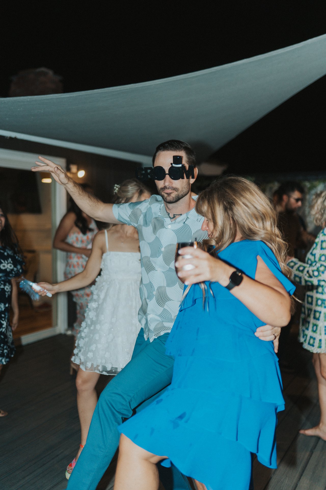 Jeremy dancing with a guest in a blue dress