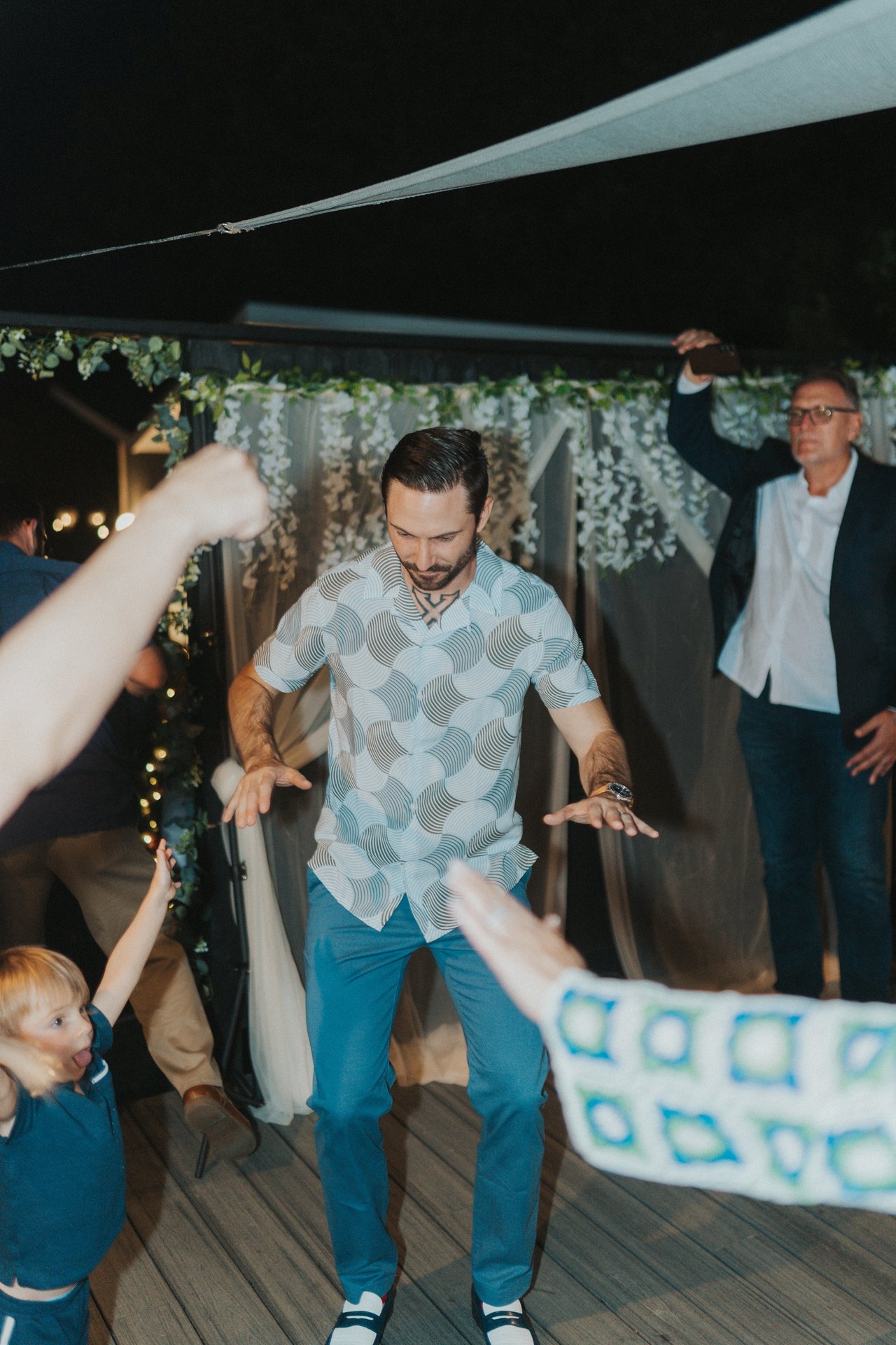 Jeremy dancing with a little guest at the edge of the floor