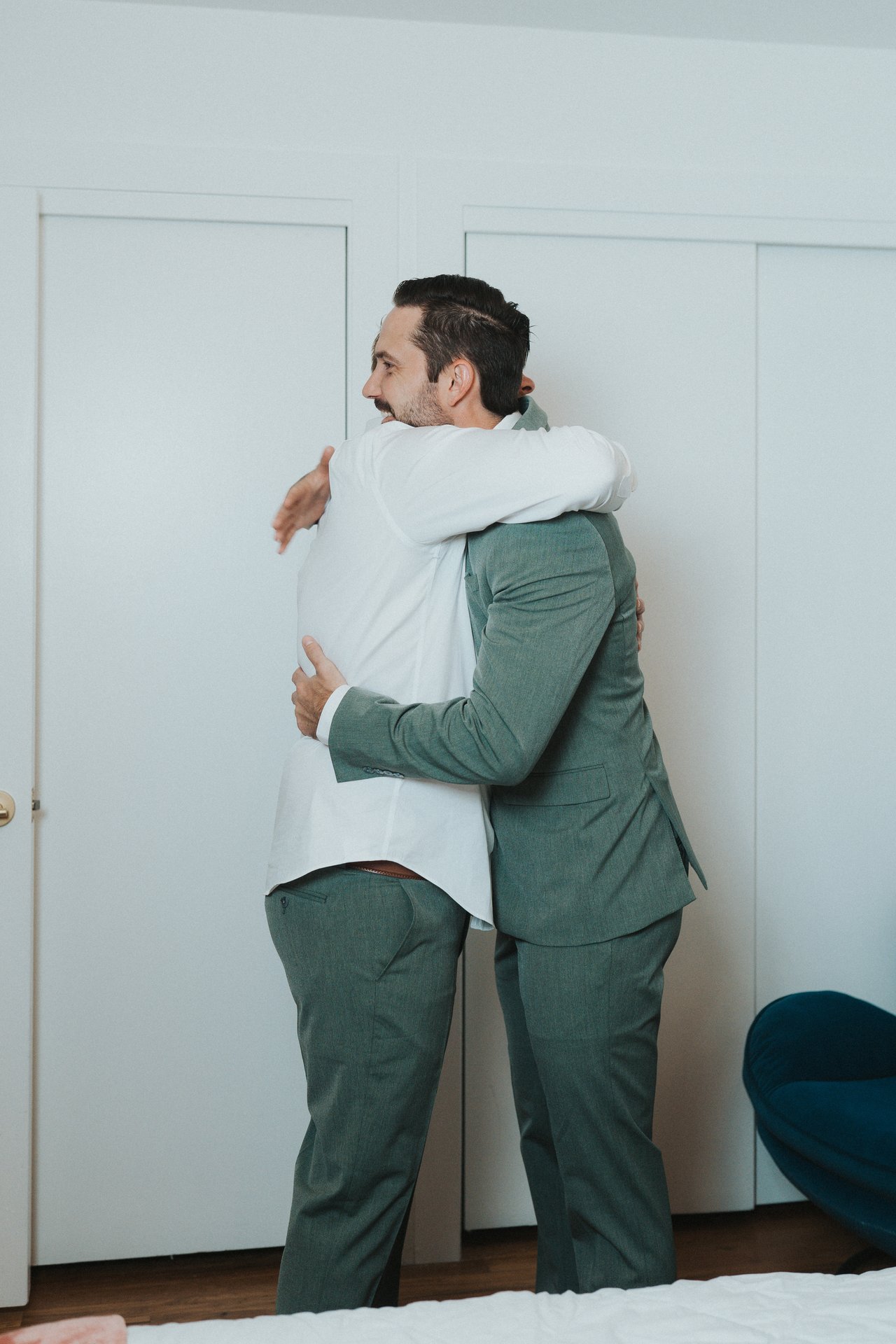 Jeremy hugs his groomsman once he is dressed