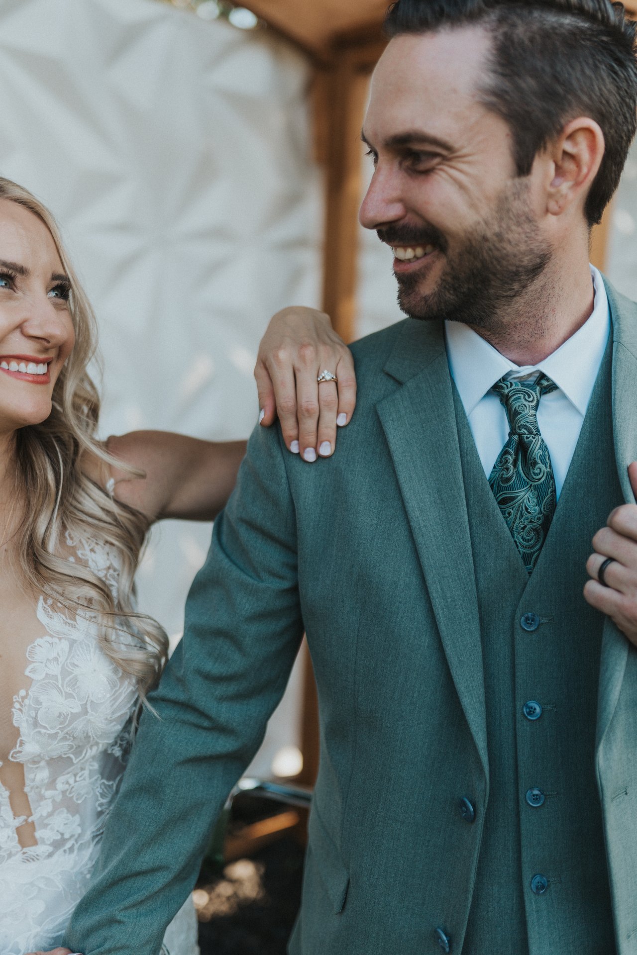 Jeremy laughs with Lexy's hand on his shoulder