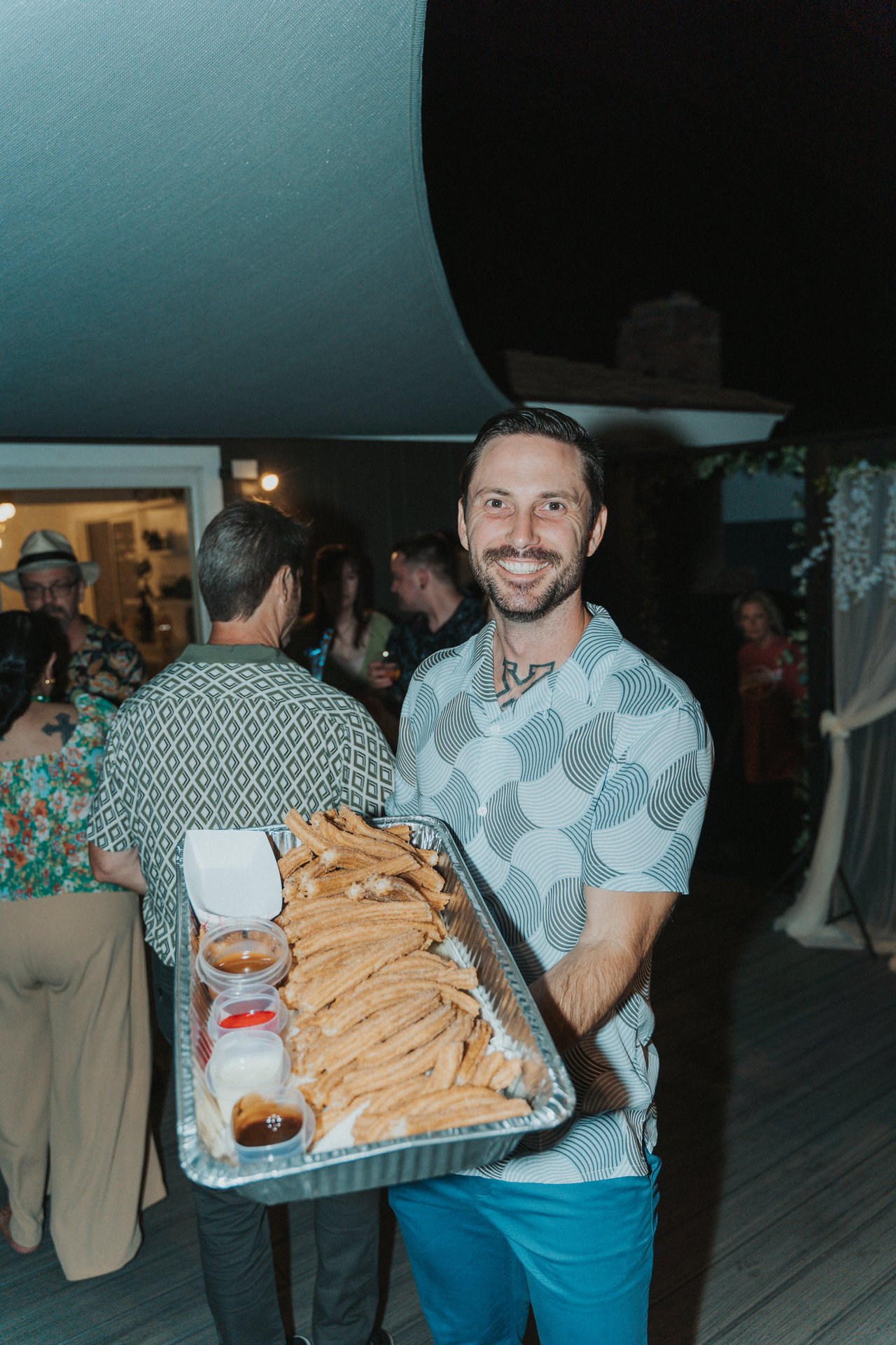 Jeremy holding a tray of churros
